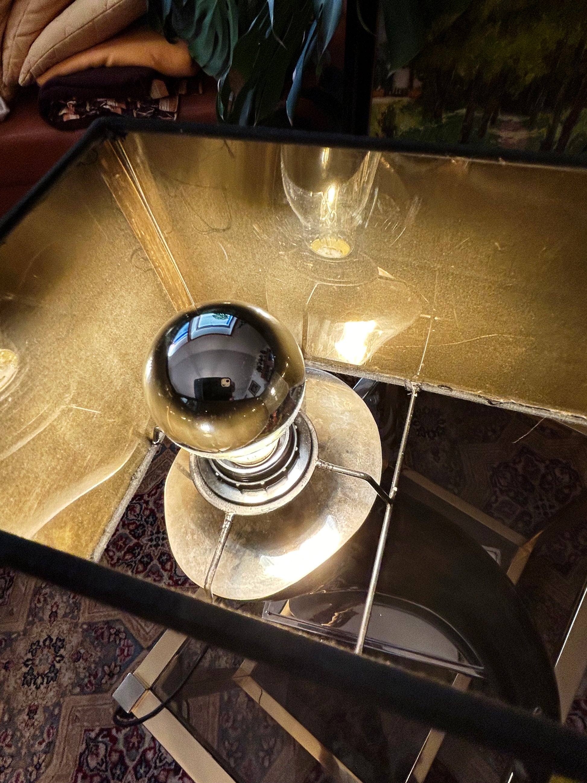 Detail of the polished nickel ball finial and metal fittings of the horn lamp