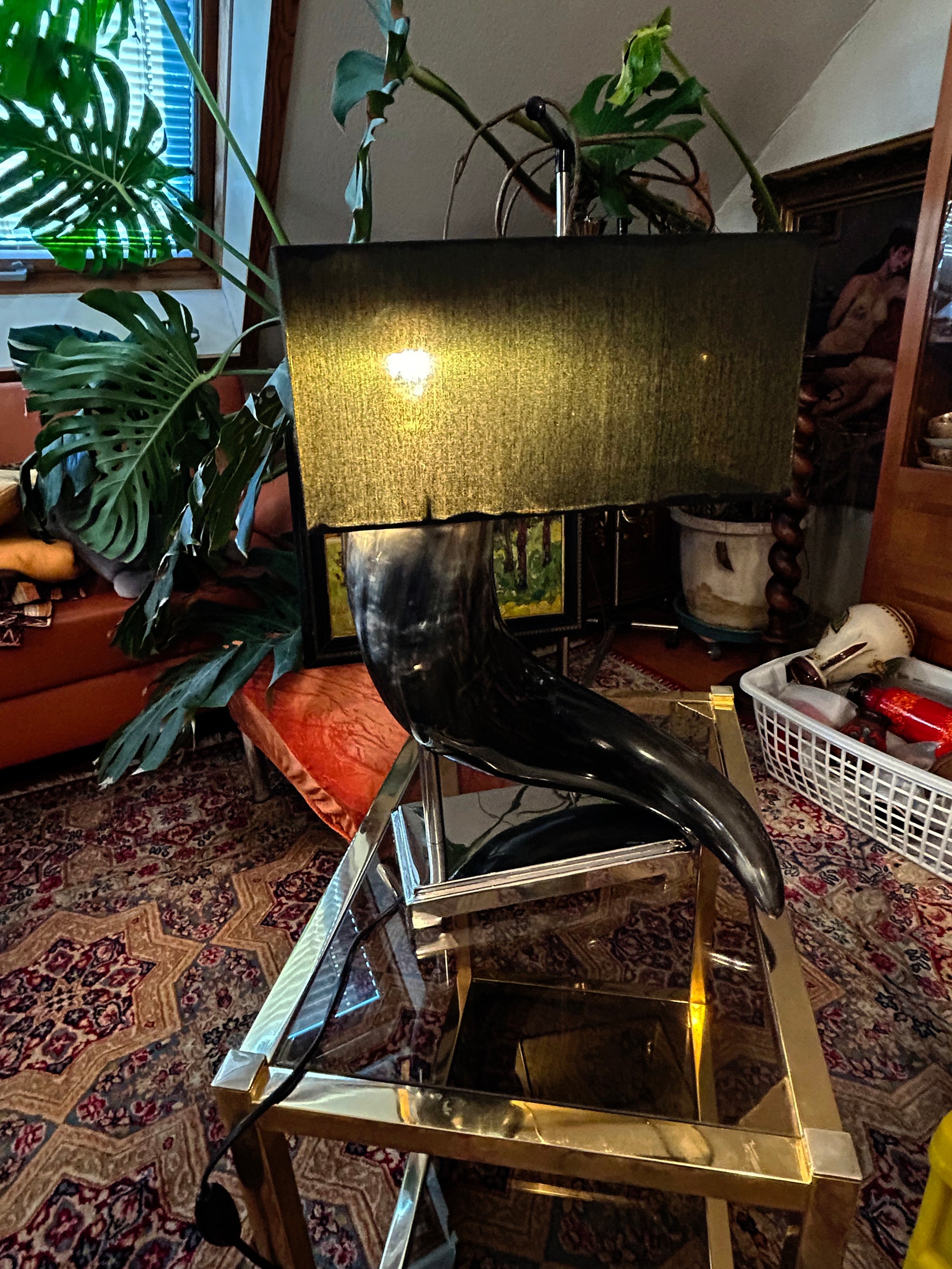 Italian horn designer lamp shown lit on a chrome and brass table for scale and context
