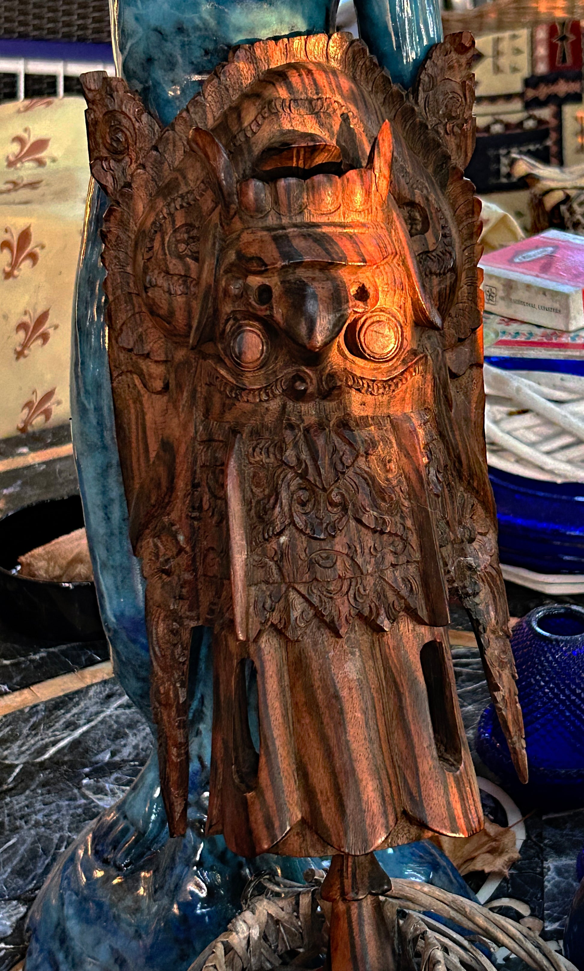 Detail of the deeply carved plumage and coromandel wood grain on the Garuda carving