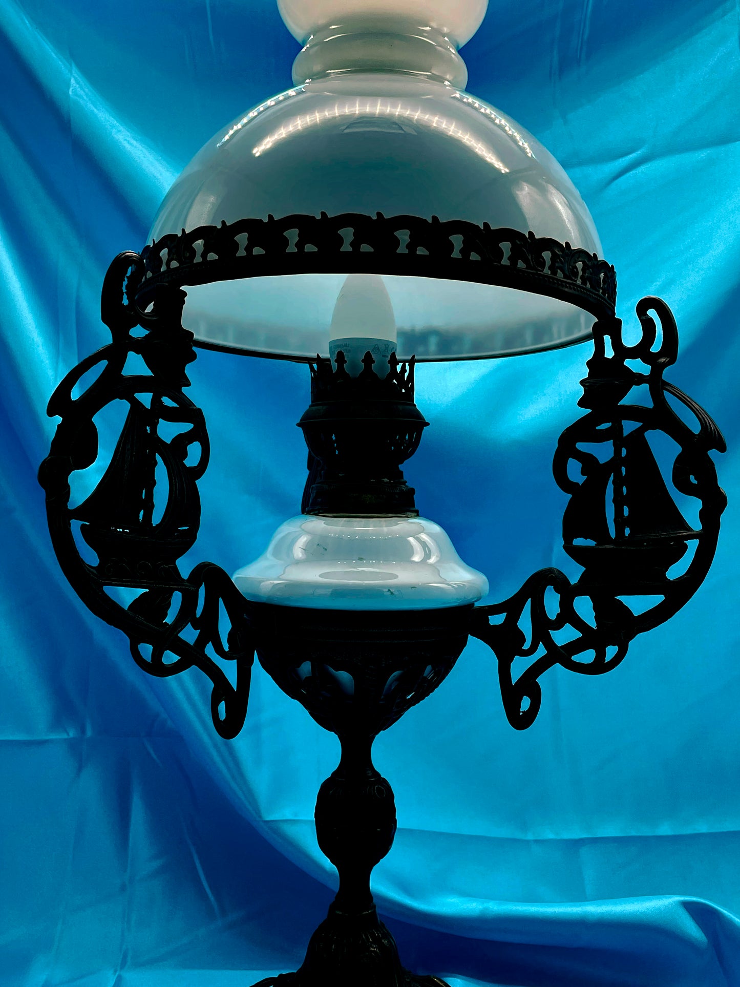 Detail of bronze base and white porcelain reservoir