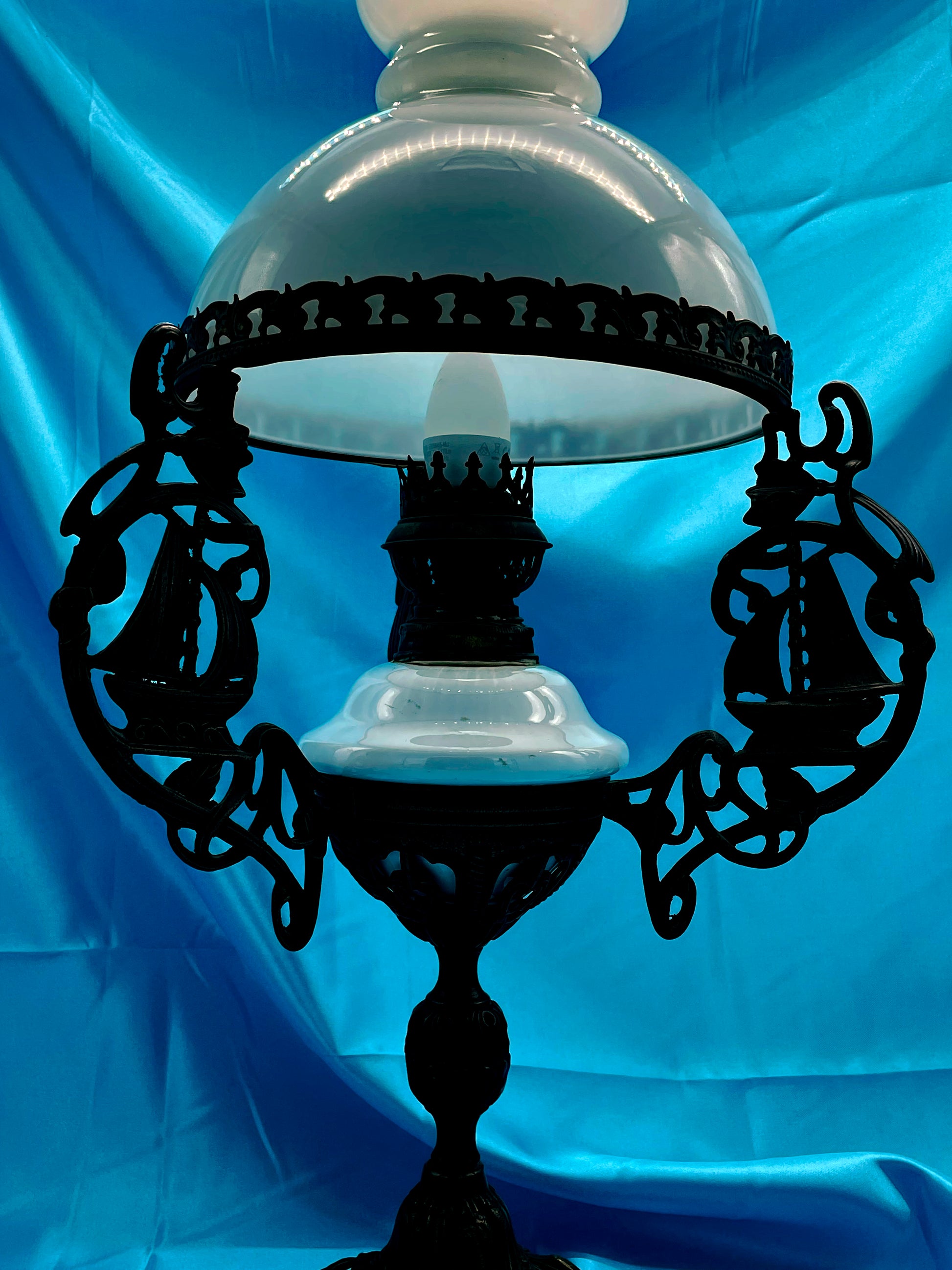 Detail of bronze base and white porcelain reservoir