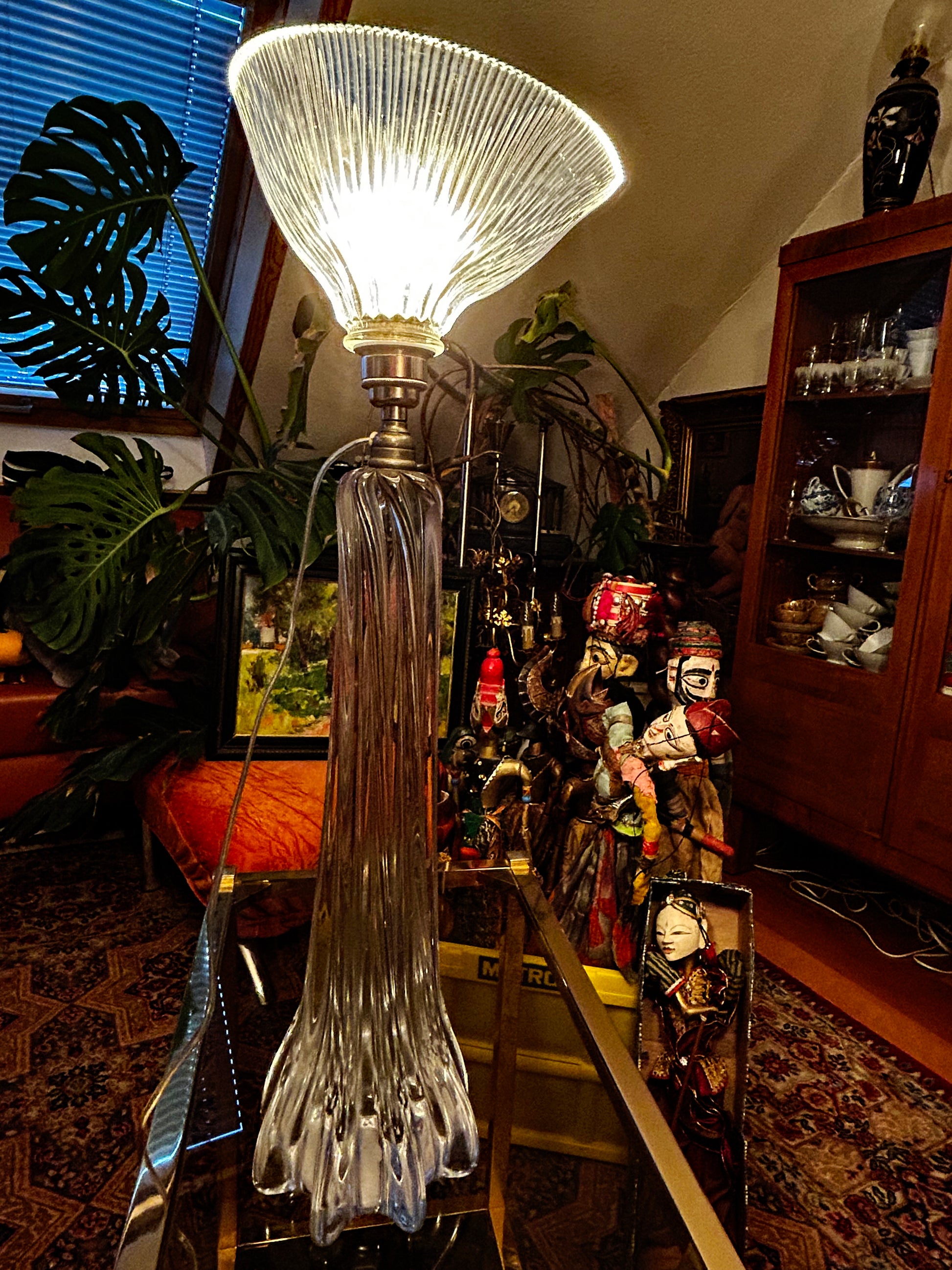 The crystal lamp illuminated, prismatic Holophane shade glowing