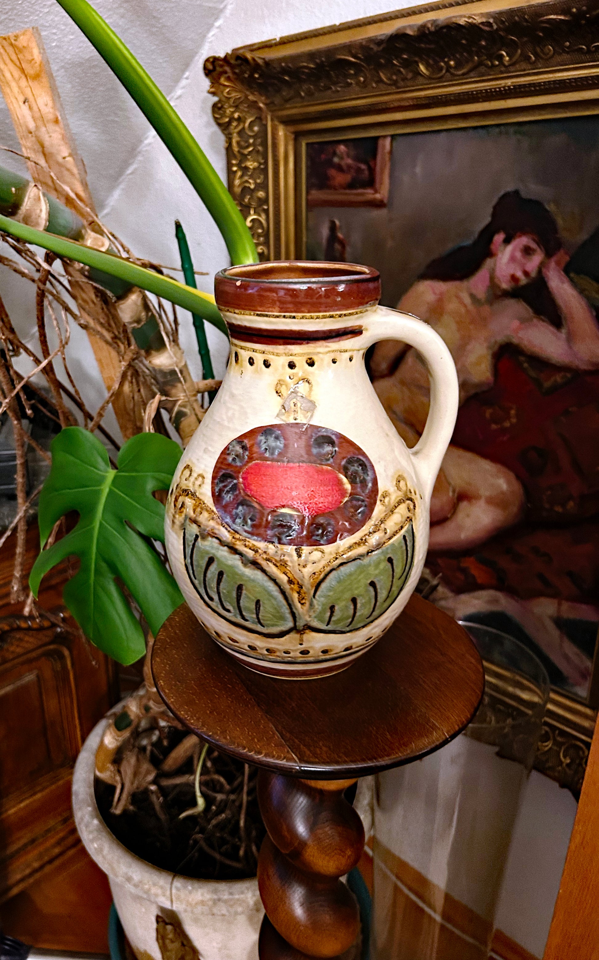 Hand-painted 1960s West German ceramic jug with cream glaze and red and green folk medallion