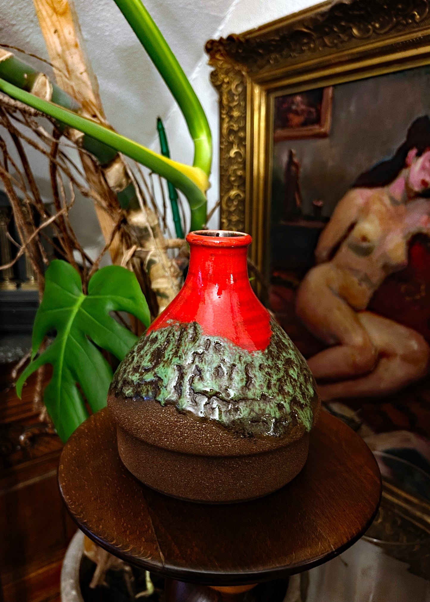 Bulbous West German fat lava bottle vase in fiery red over mossy green volcanic glaze
