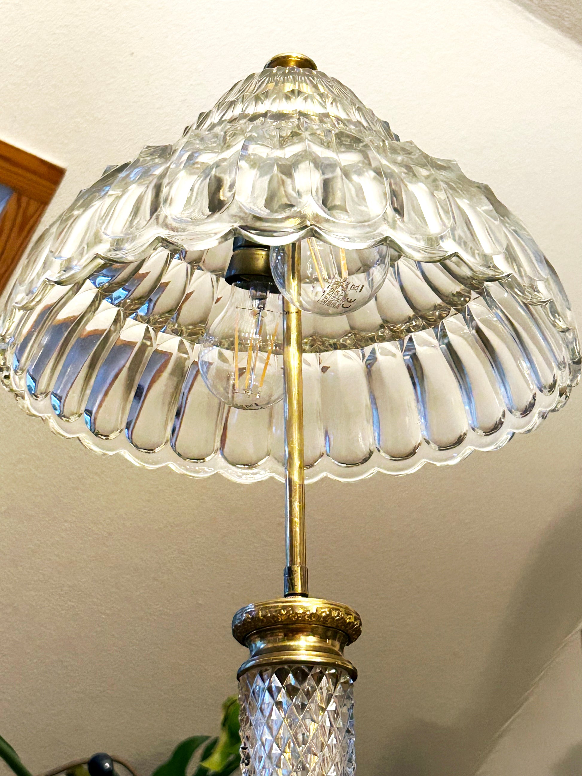 Underside of the crystal dome shade showing socket and brass stem