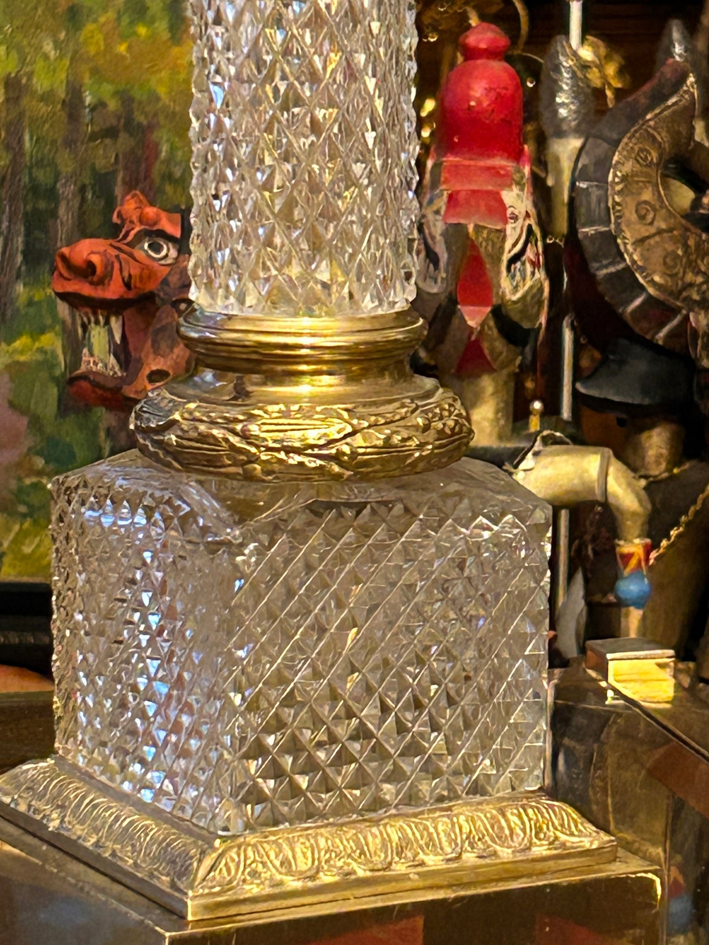 Faceted square crystal plinth with ornate chased gilt brass base mounts