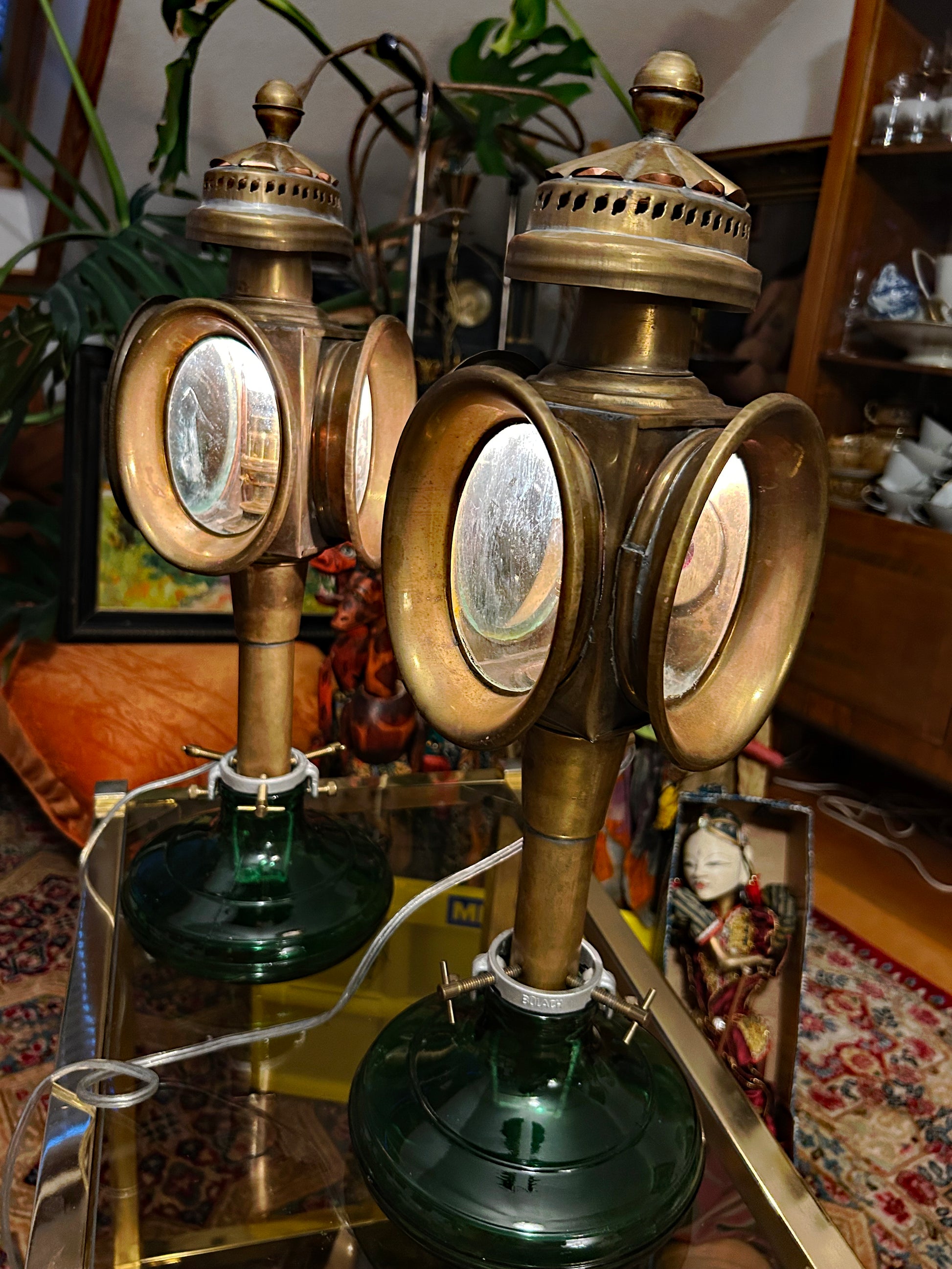 Pair of carriage lamps showing bullseye front lenses and green glass feet