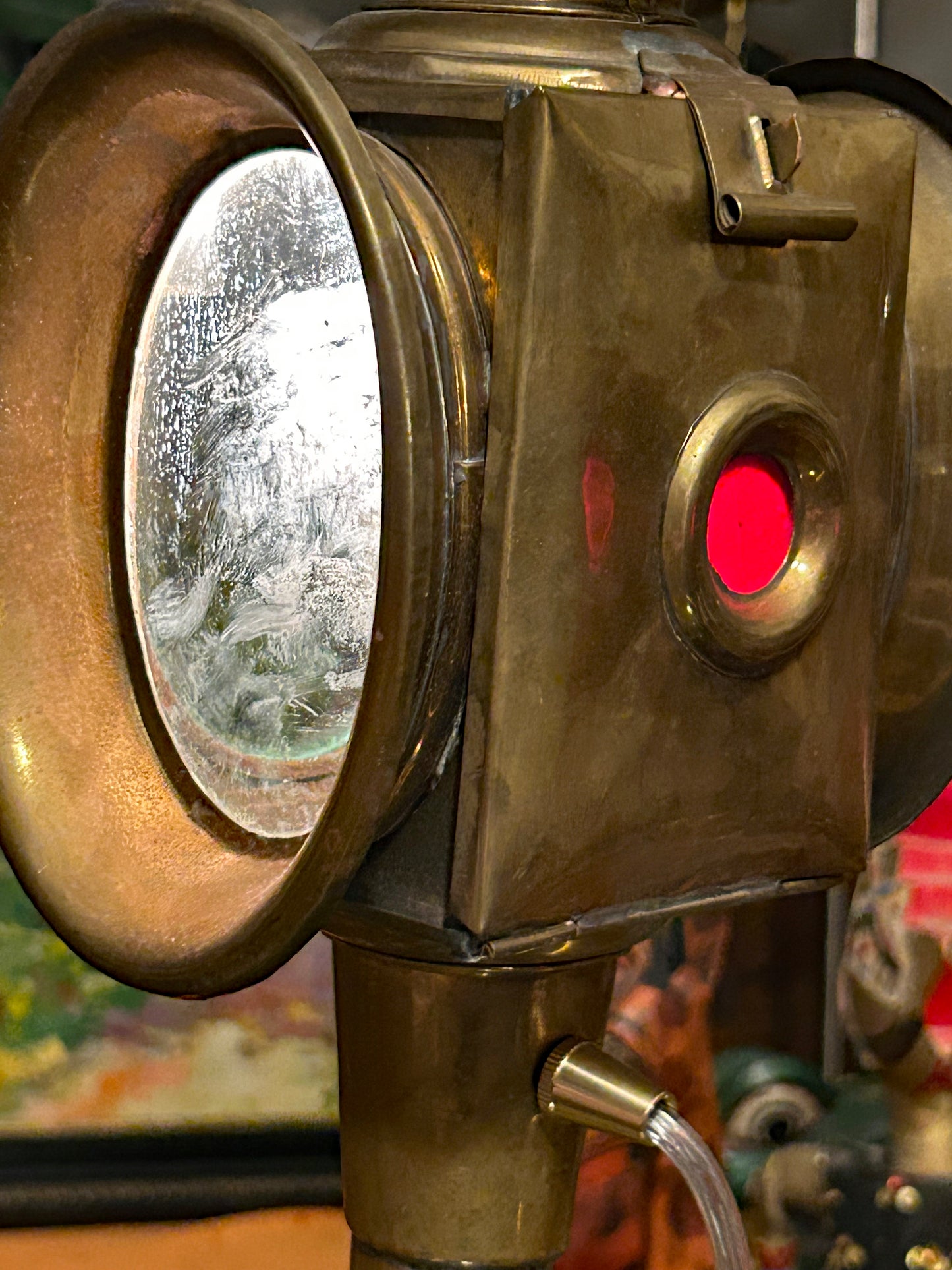 Detail of brass carriage lamp bullseye front lens and ruby-red side jewel