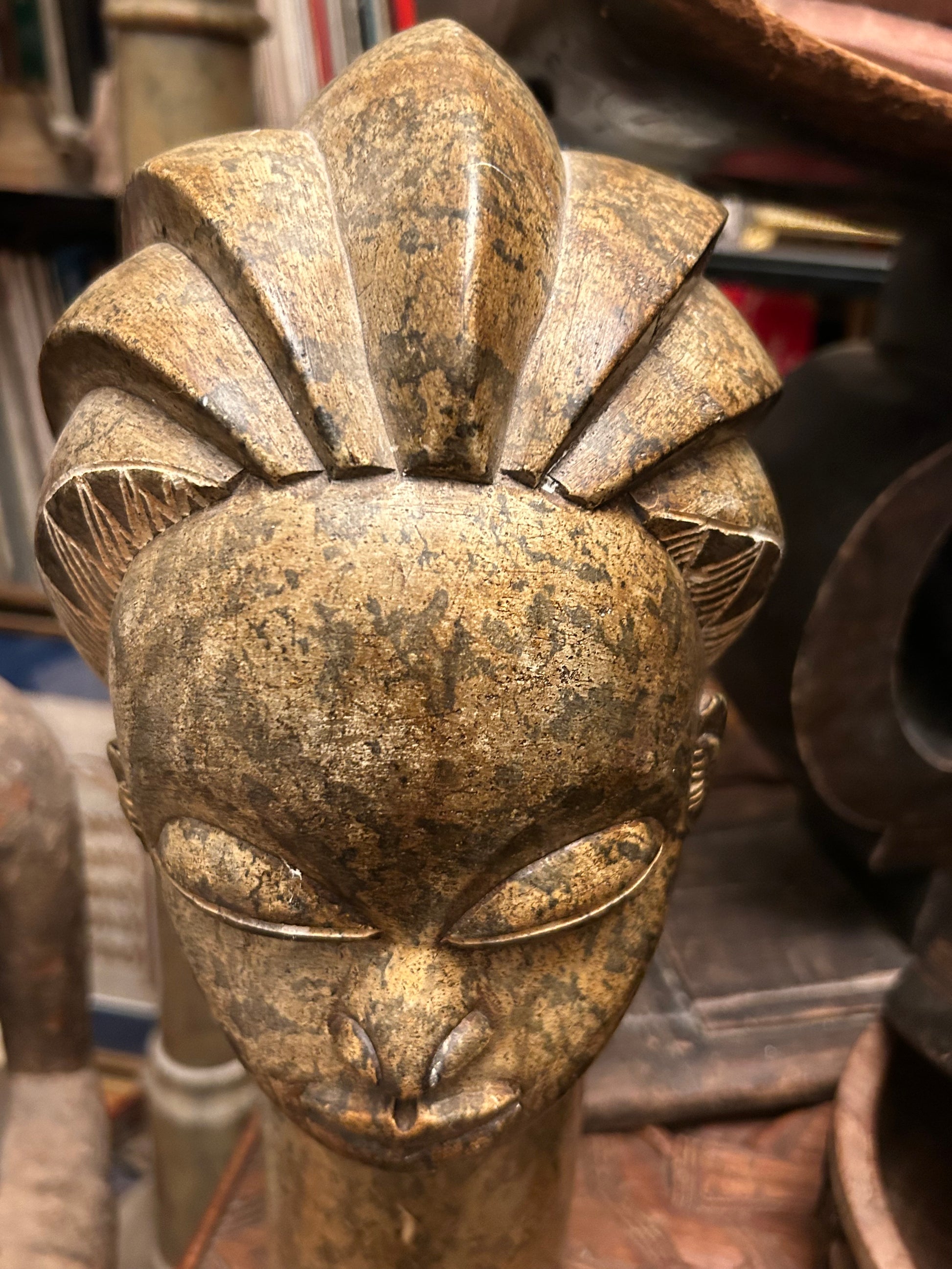 Crown detail of the African stone head sculpture showing fluted braided coiffure
