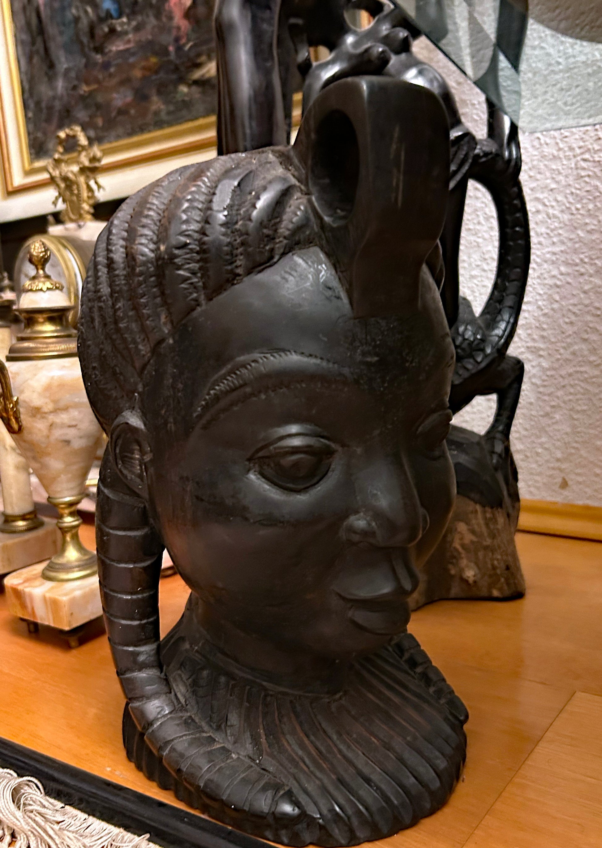 Frontal three-quarter view of ebony Yoruba-style African head sculpture face