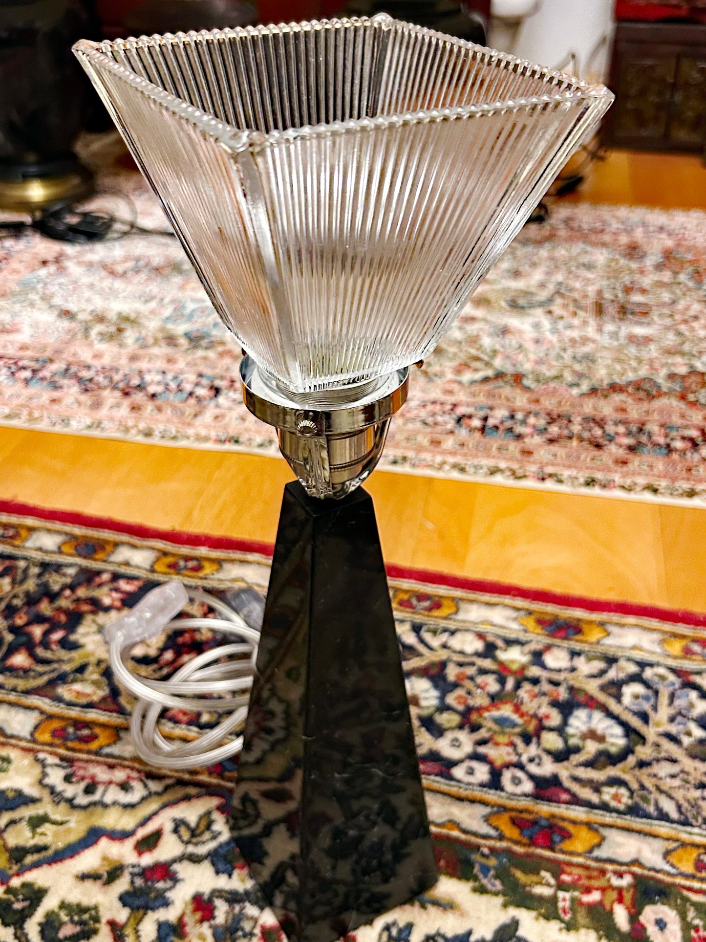 Art Déco black marble obelisk table lamp with prismatic Holophane glass shade, full straight-on view