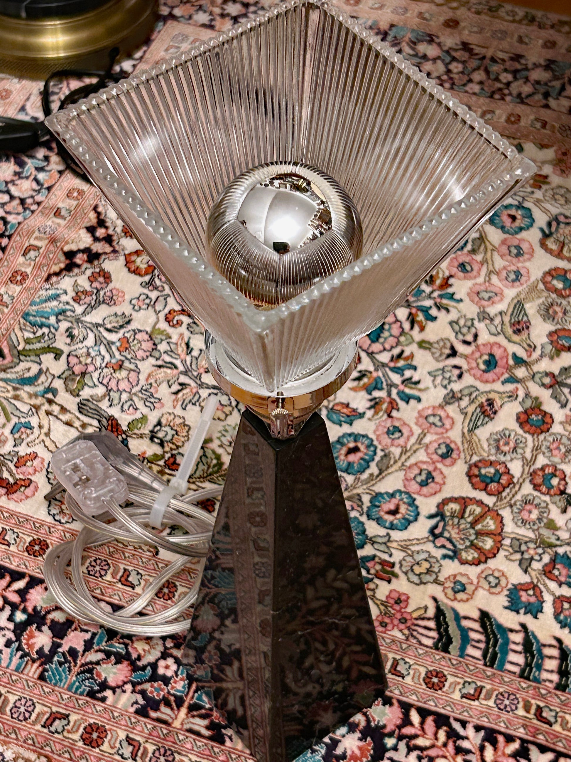 Top-down detail of the prismatic Holophane glass shade and socket