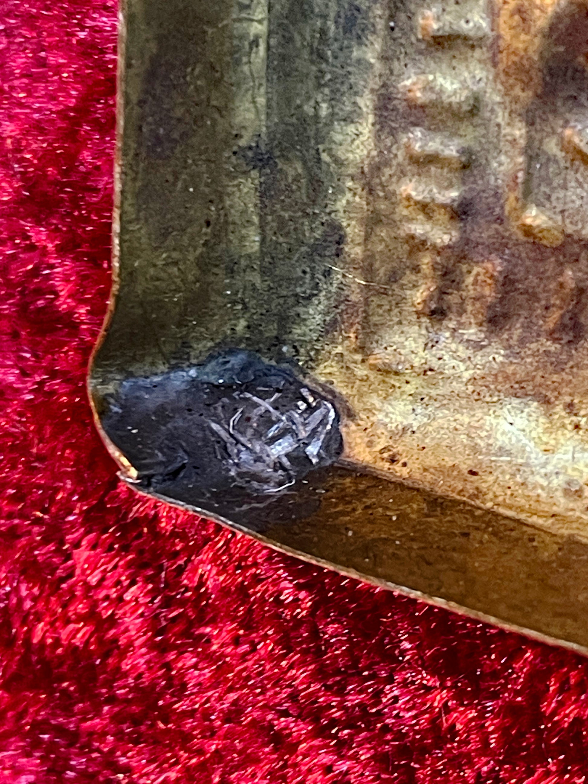 Maker's seal stamped on the reverse of the brass relief