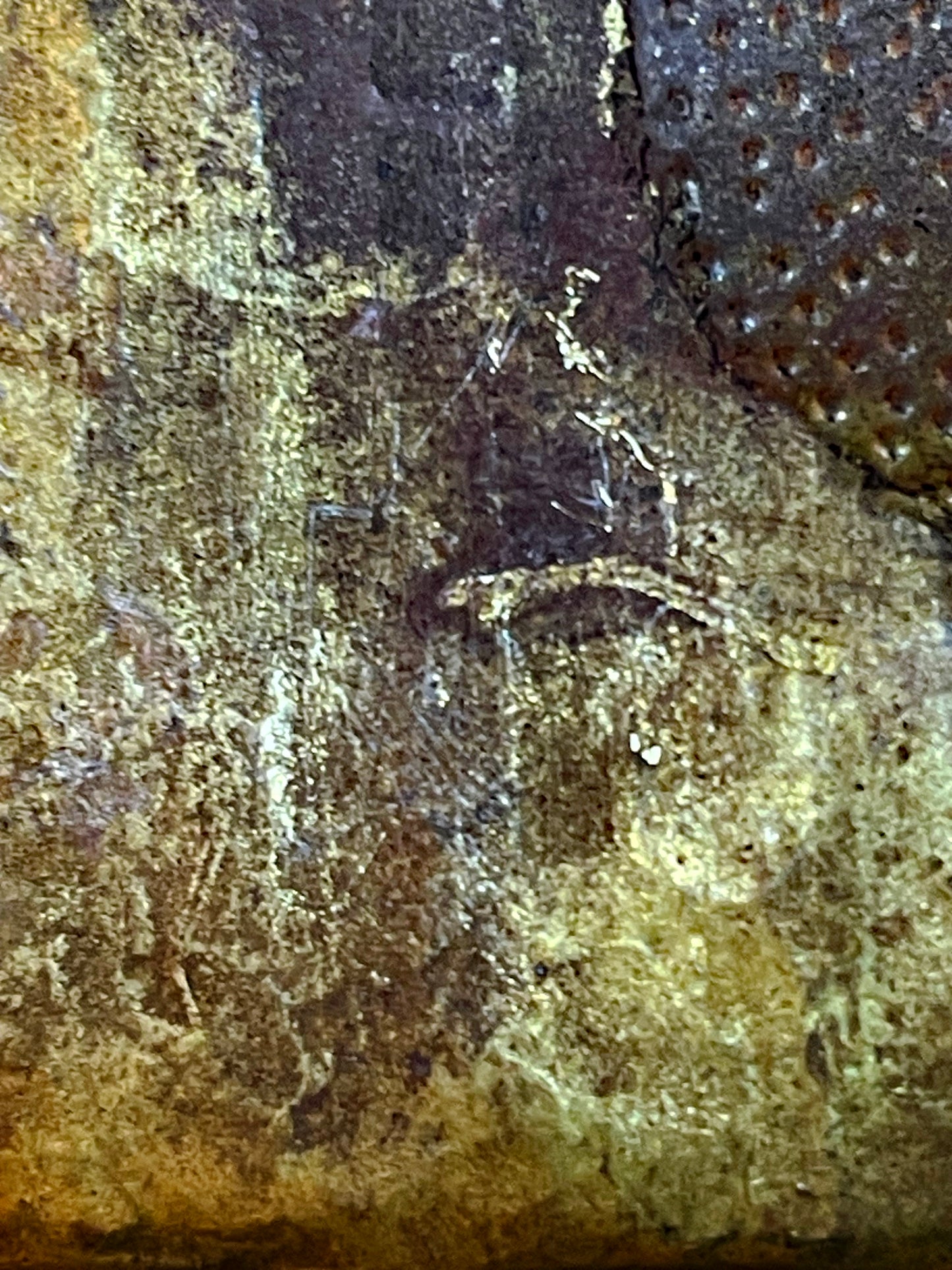 Incised artisan marks on the back of the plaque