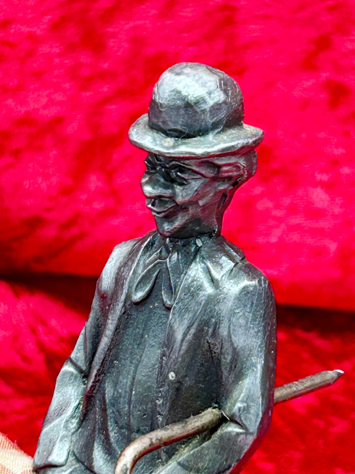 Detailed view of silvered Chaplin figure face and cast clothing patina