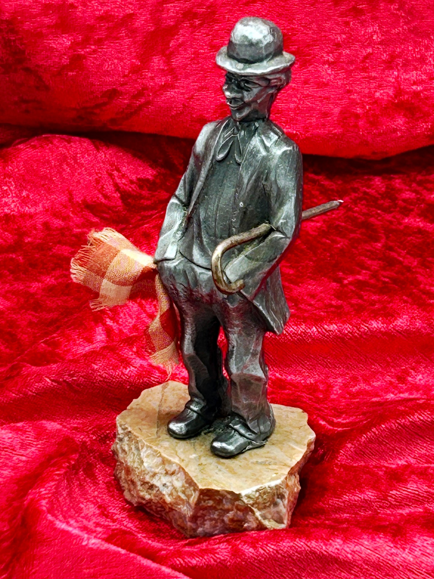 Vintage Chaplin Little Tramp statuette with cane and scarf, three quarter view on marble base
