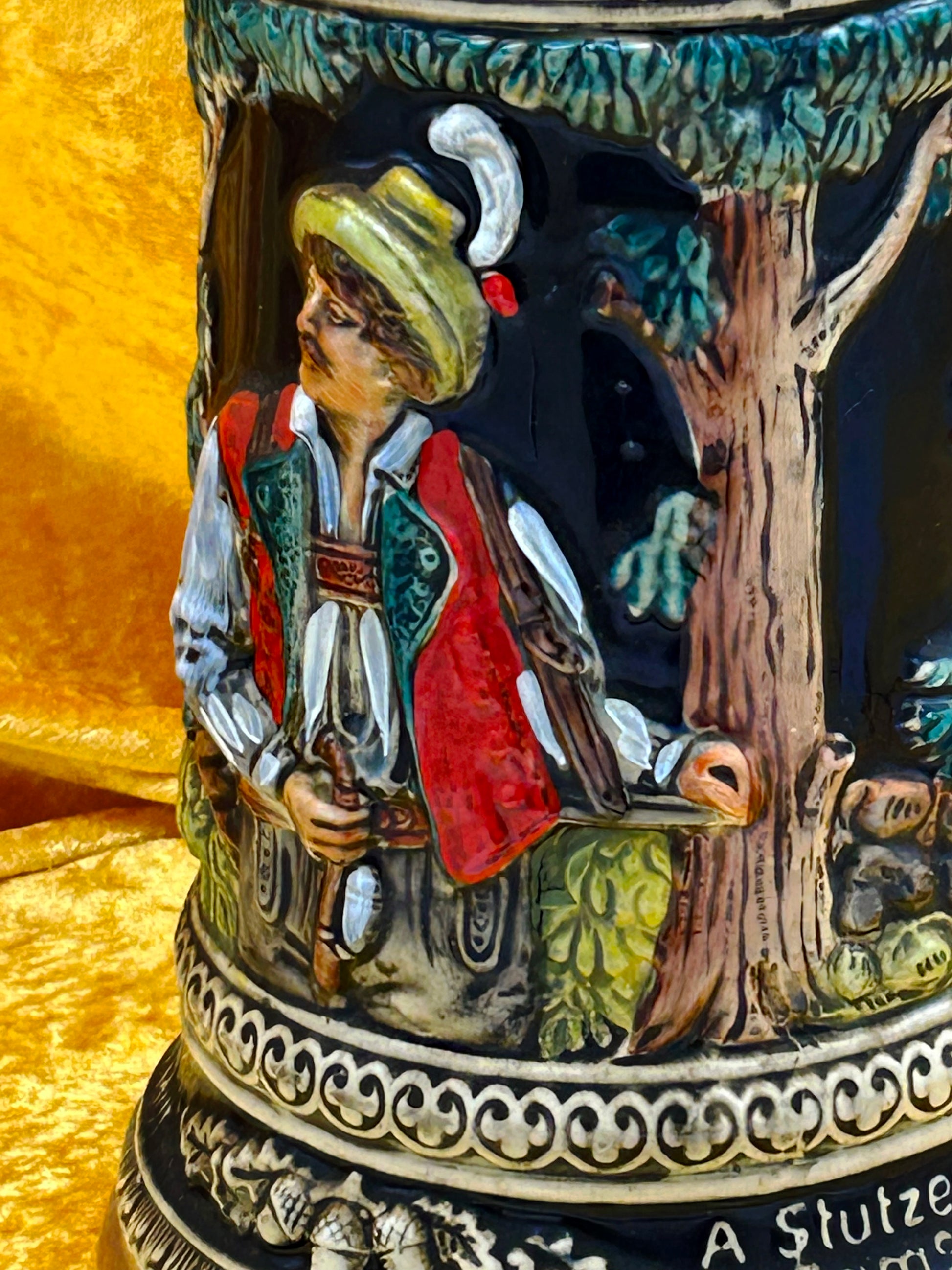 Close-up relief detail of Bavarian hunter in red waistcoat and feathered hat