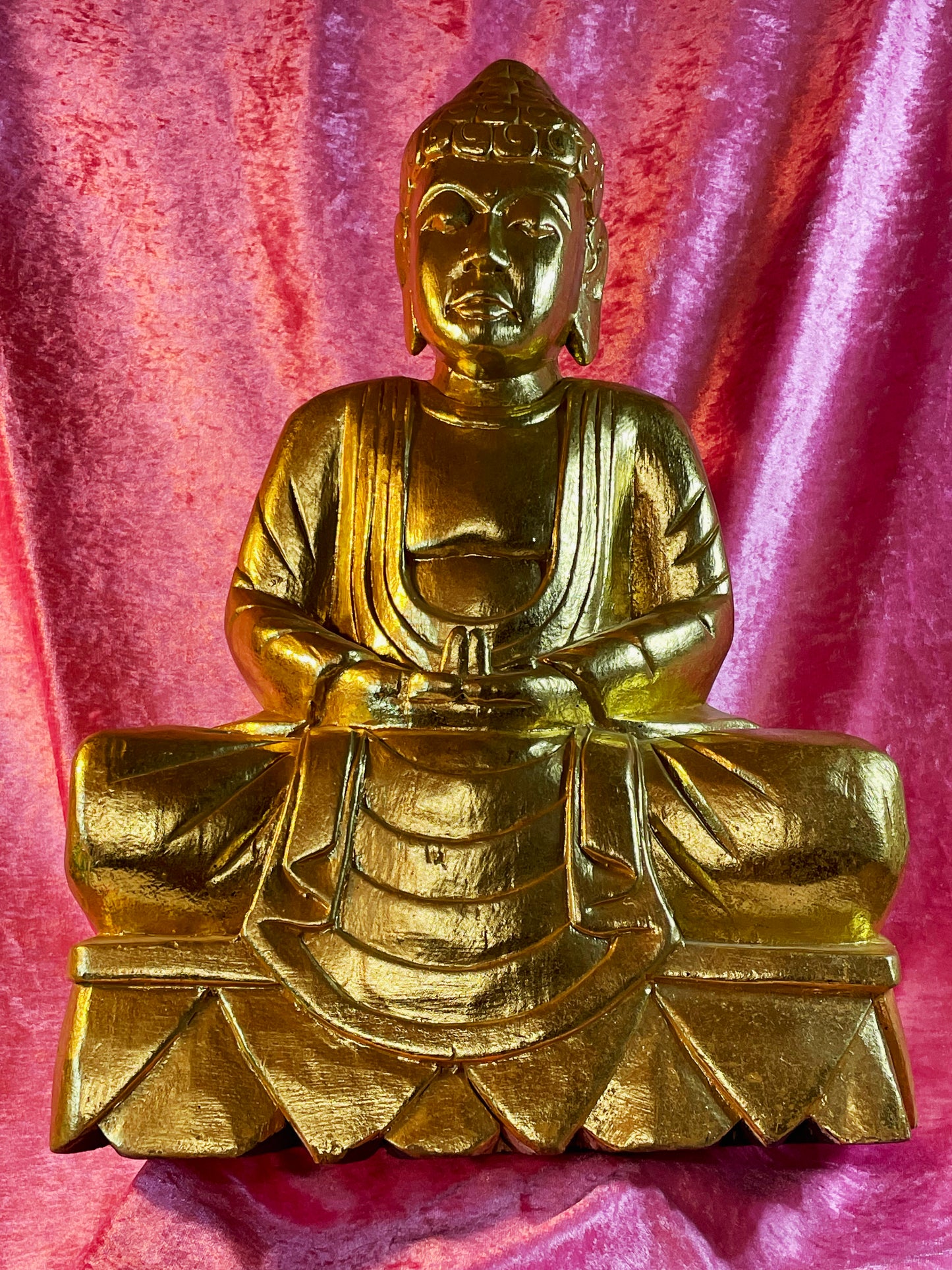 Gold wood Buddha seated in meditation, full front view of carved lotus base
