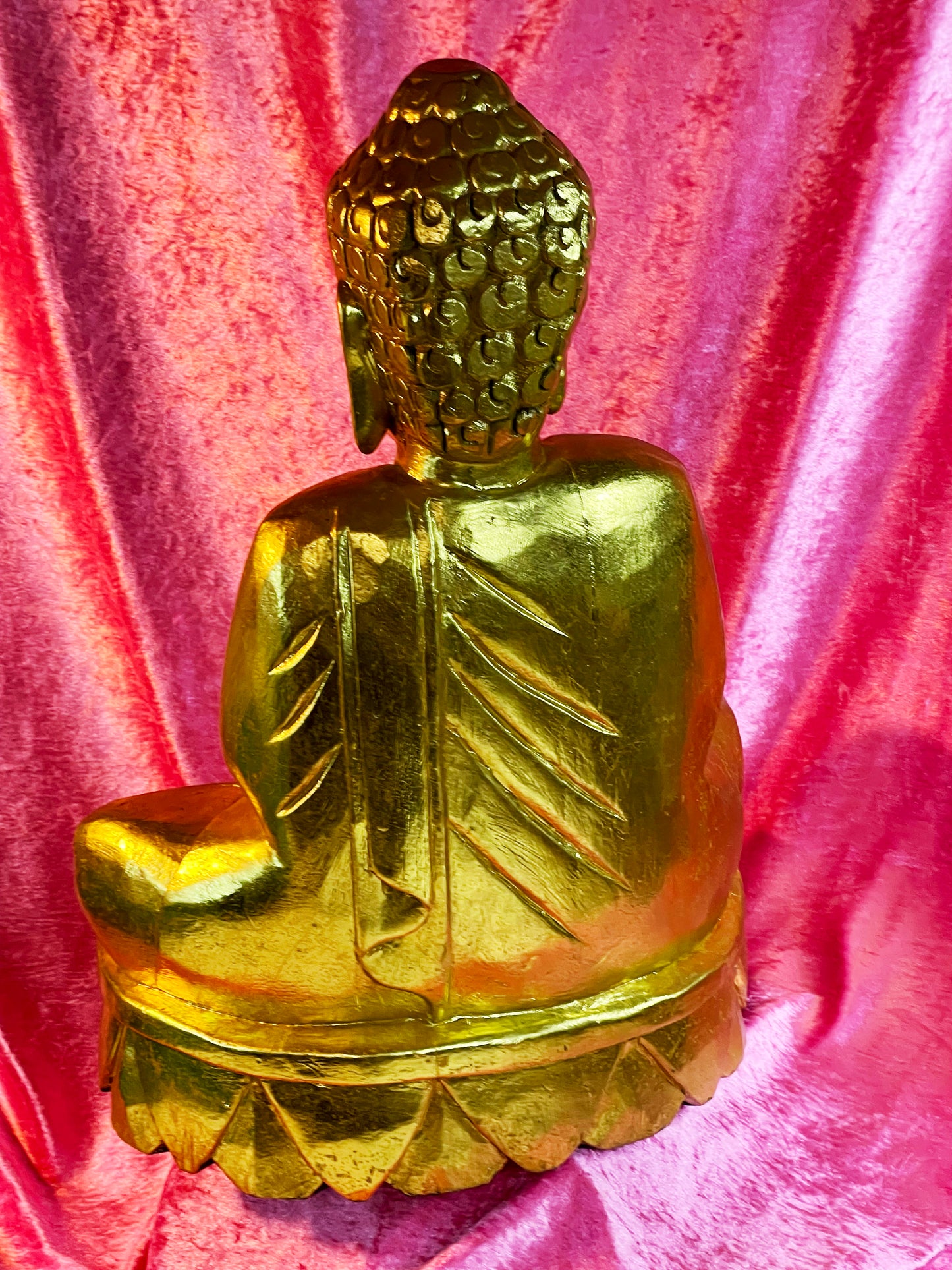 Carved back of the gilt wood Buddha showing flowing robe folds