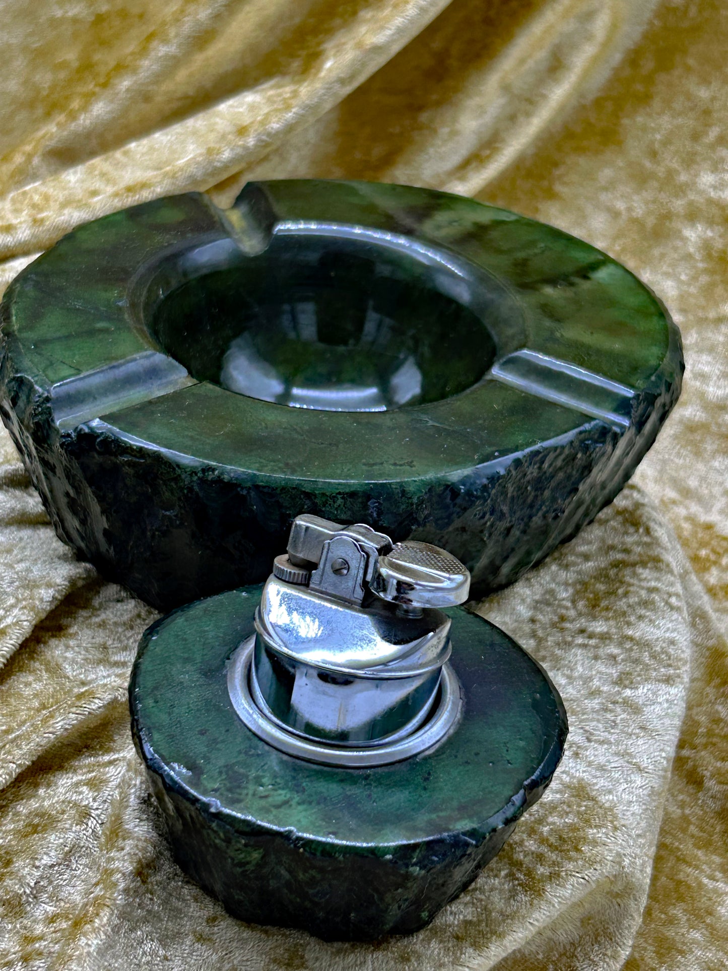 Detail of green onyx marble ashtray and chrome table lighter mechanism