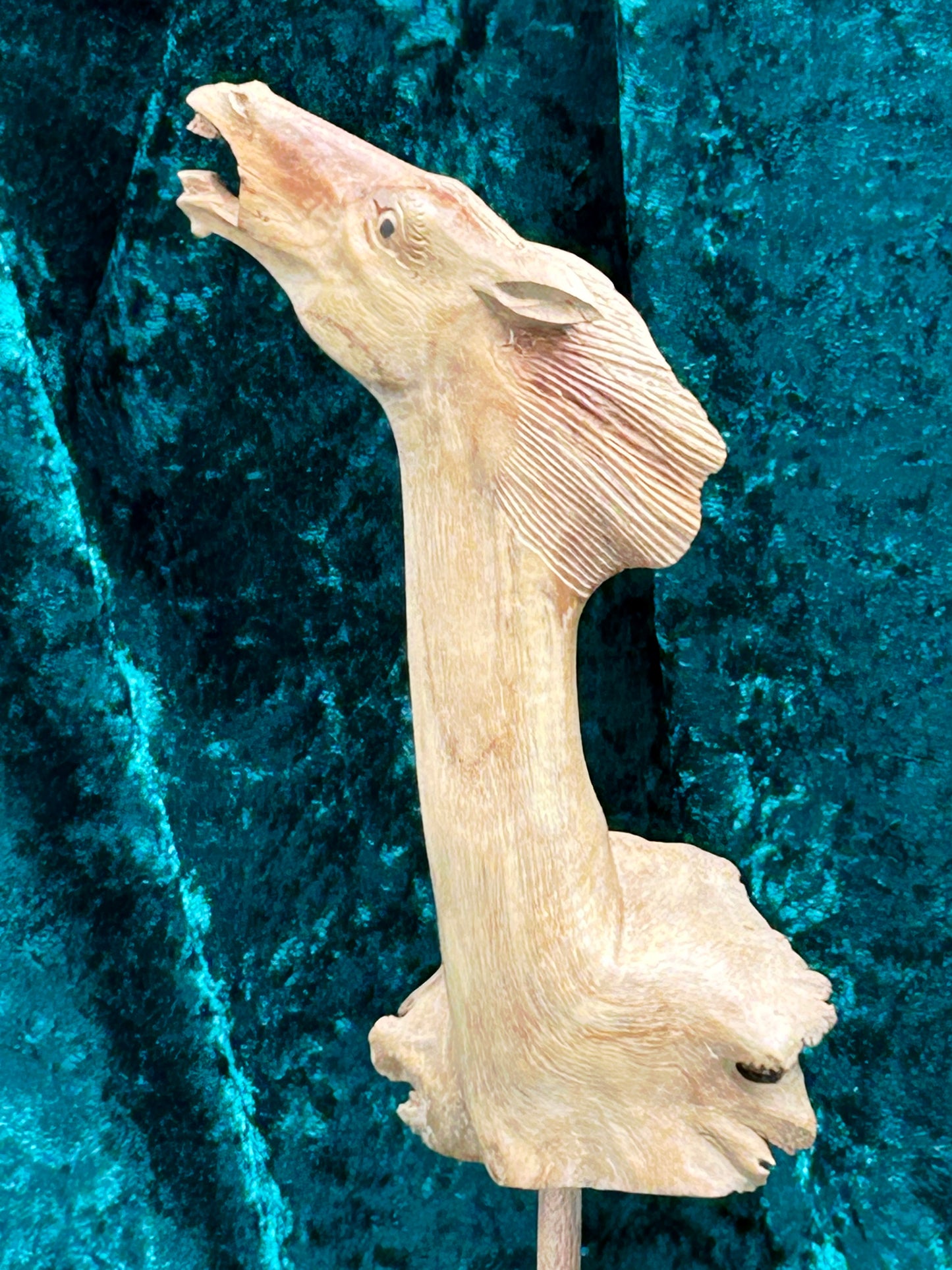 Sharp profile of hand-carved horse head showing open mouth and mane detail