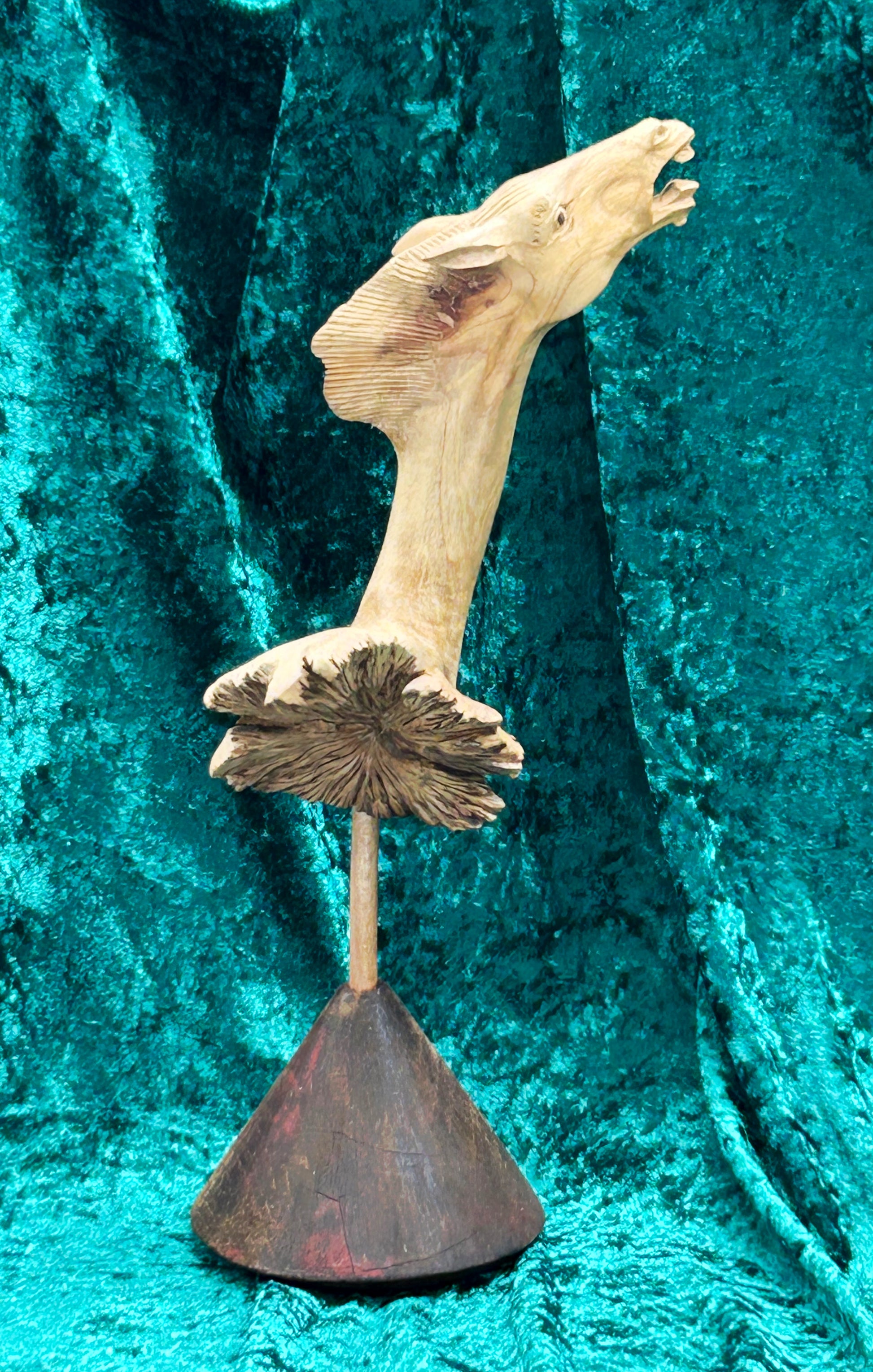 Full view of carved Wurzelholz horse figure with conical wooden base, Indonesia