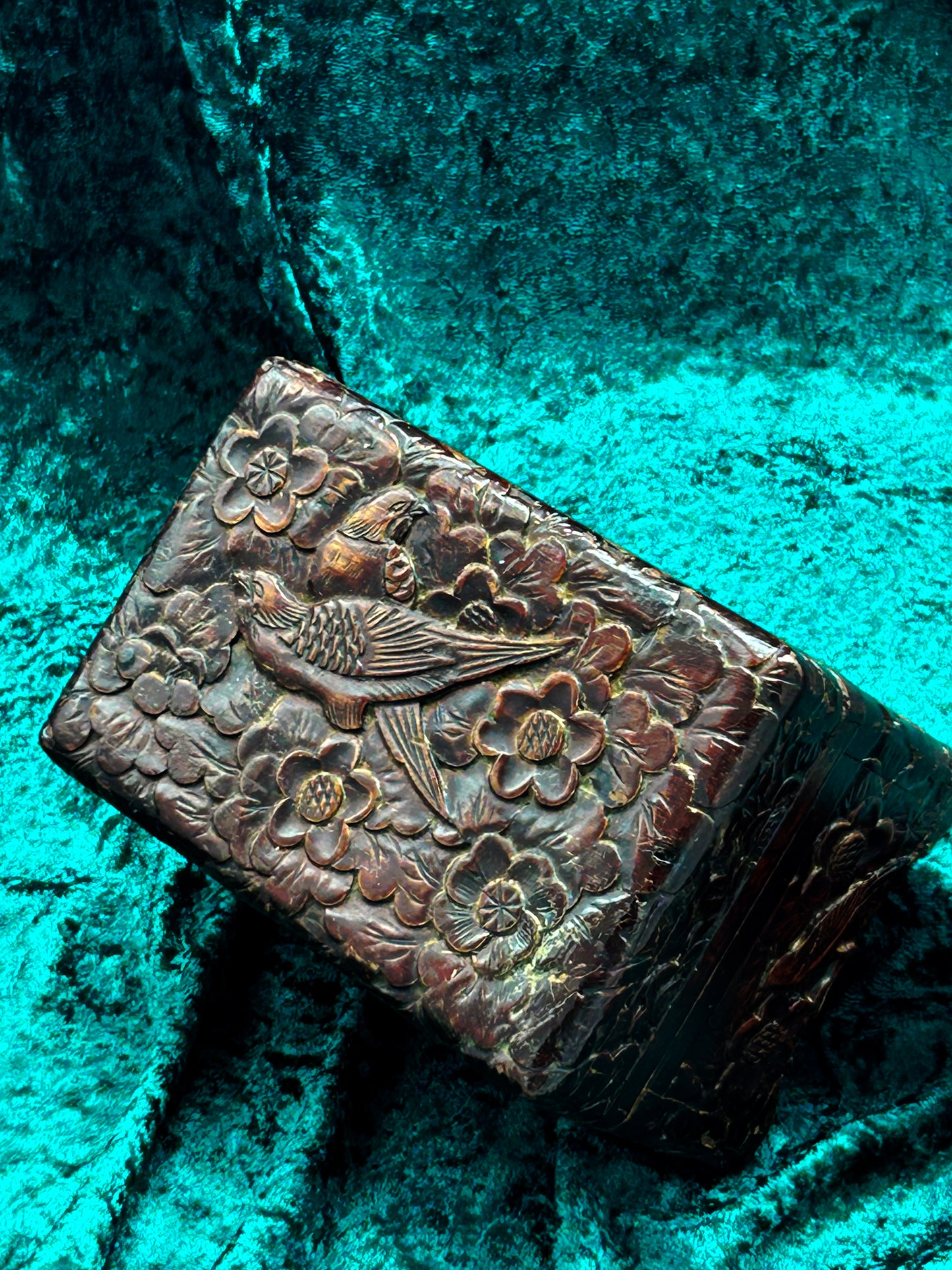 Carved wooden box lid showing a pheasant gliding through cherry blossoms
