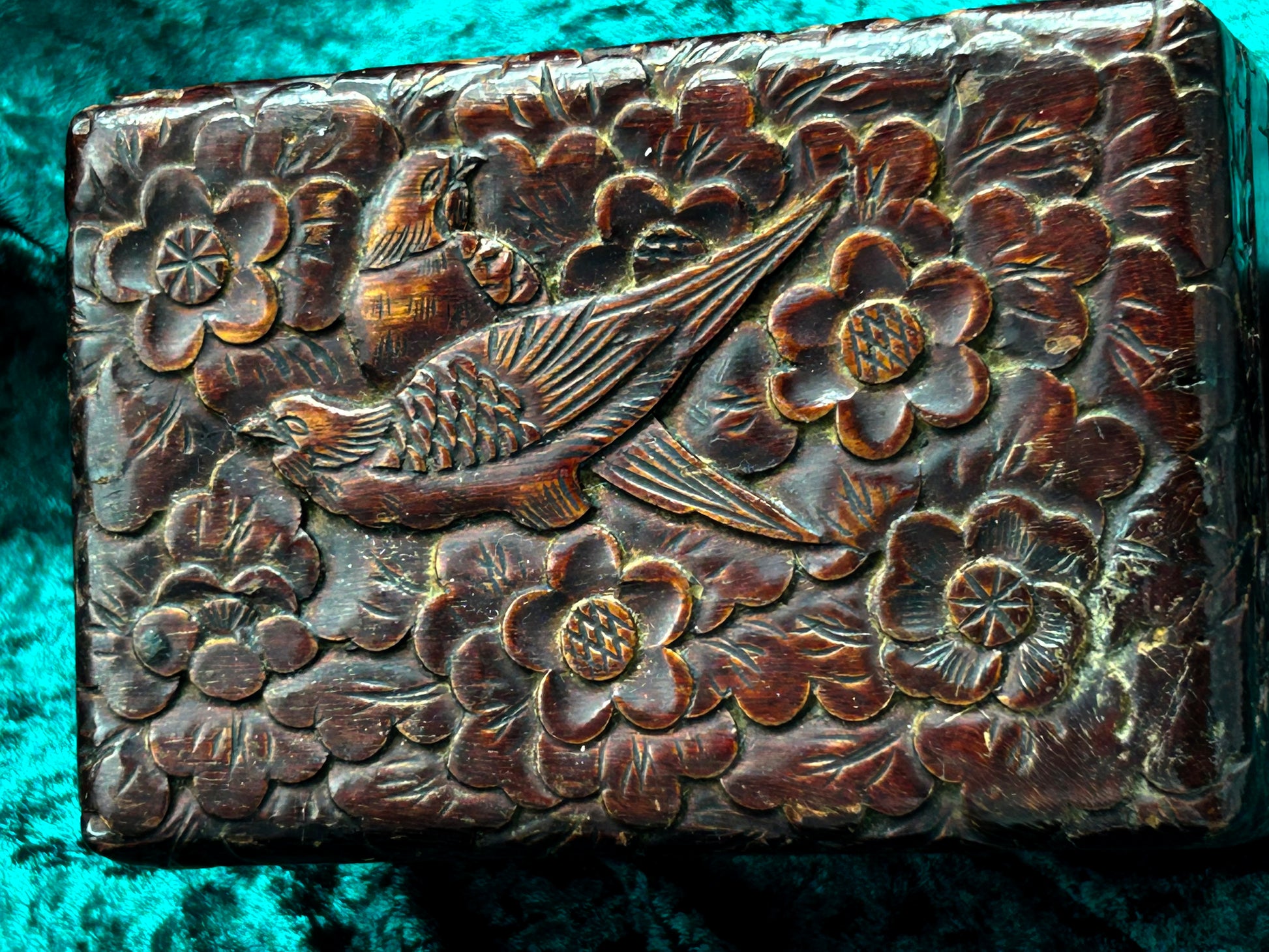 Close-up detail of the deeply carved pheasant and blossom relief