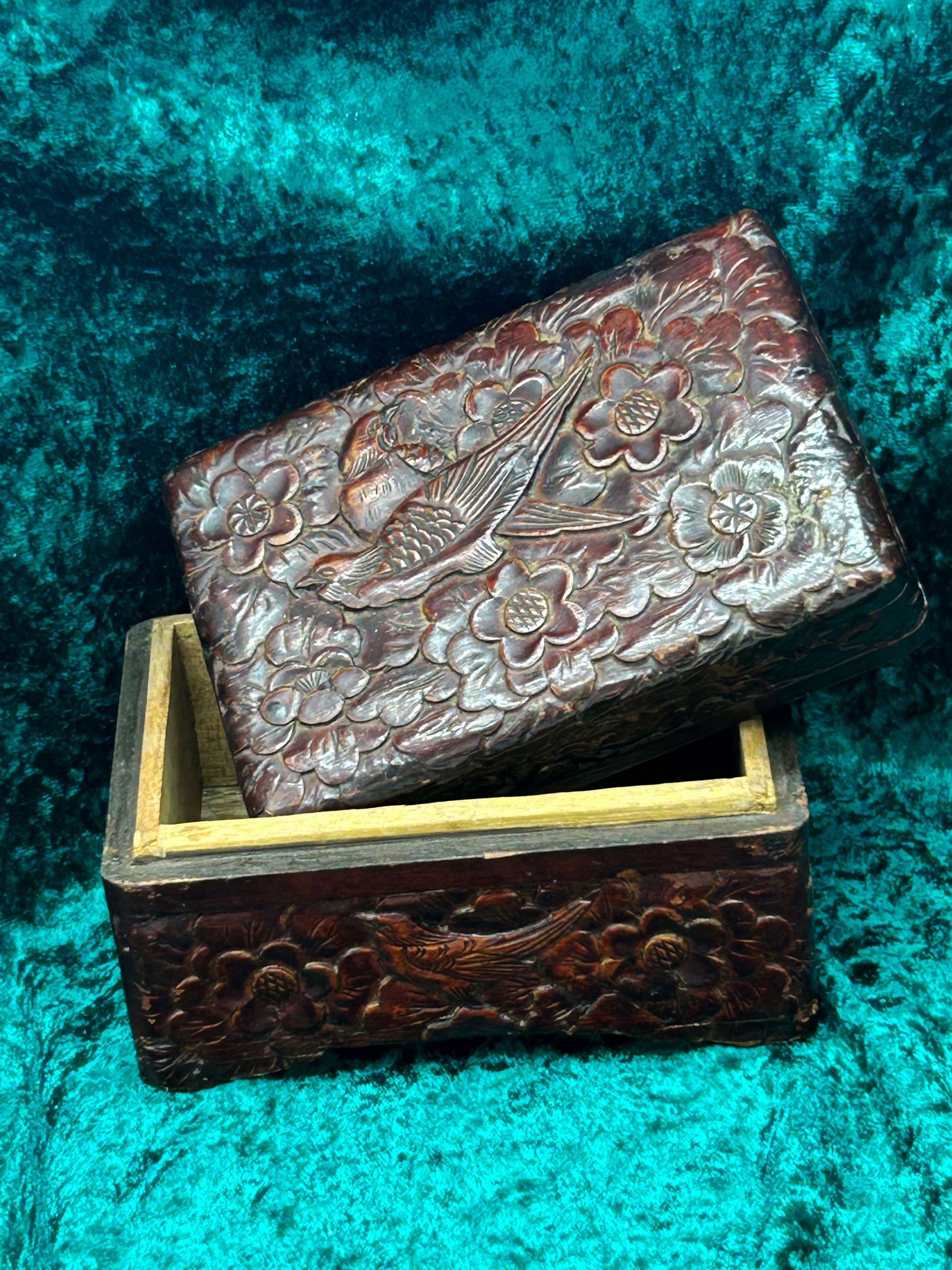 Japanese carved box open with lid resting ajar and carved side panels