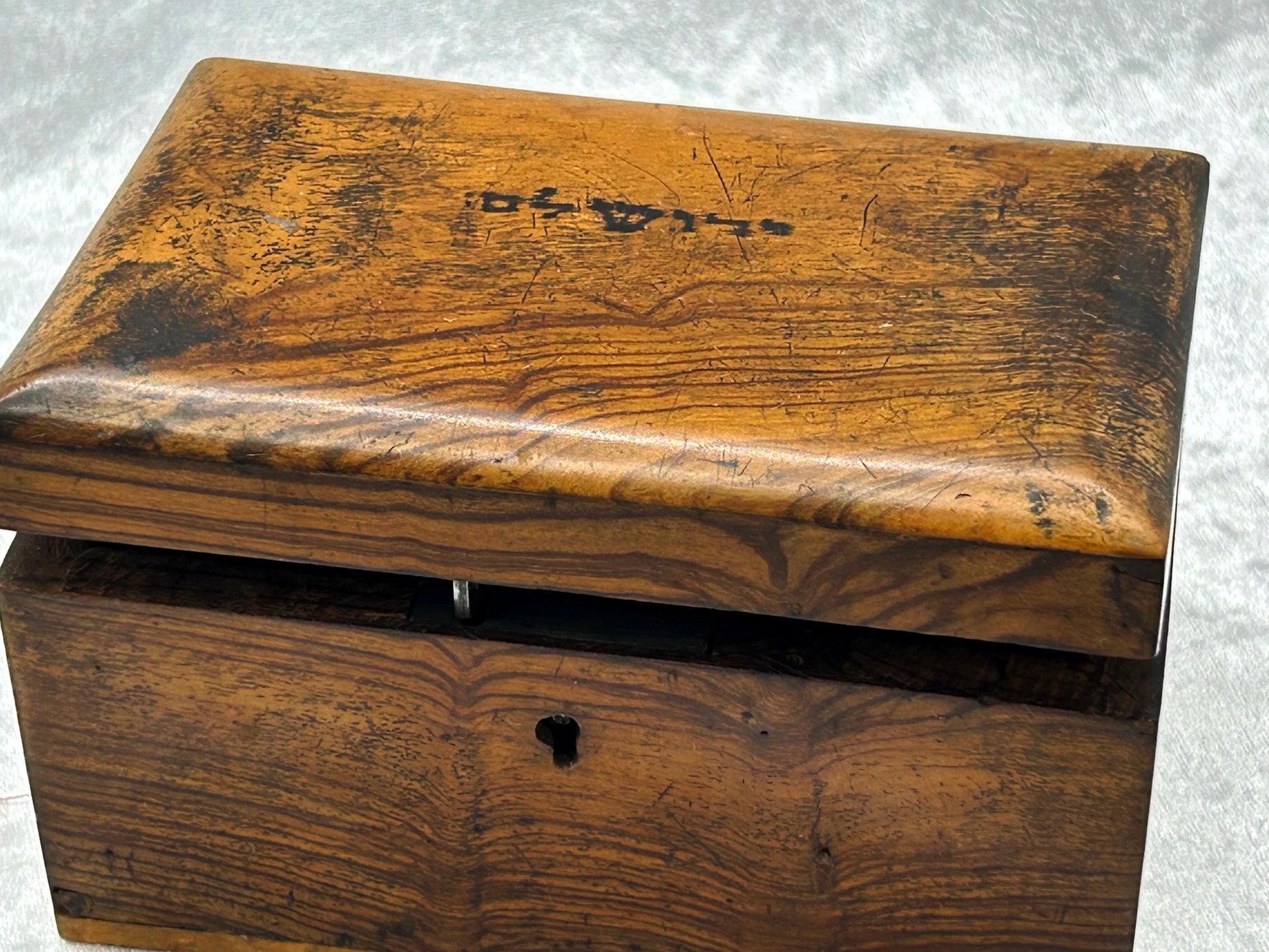 Olive wood box with lid ajar showing brass hinge mechanism