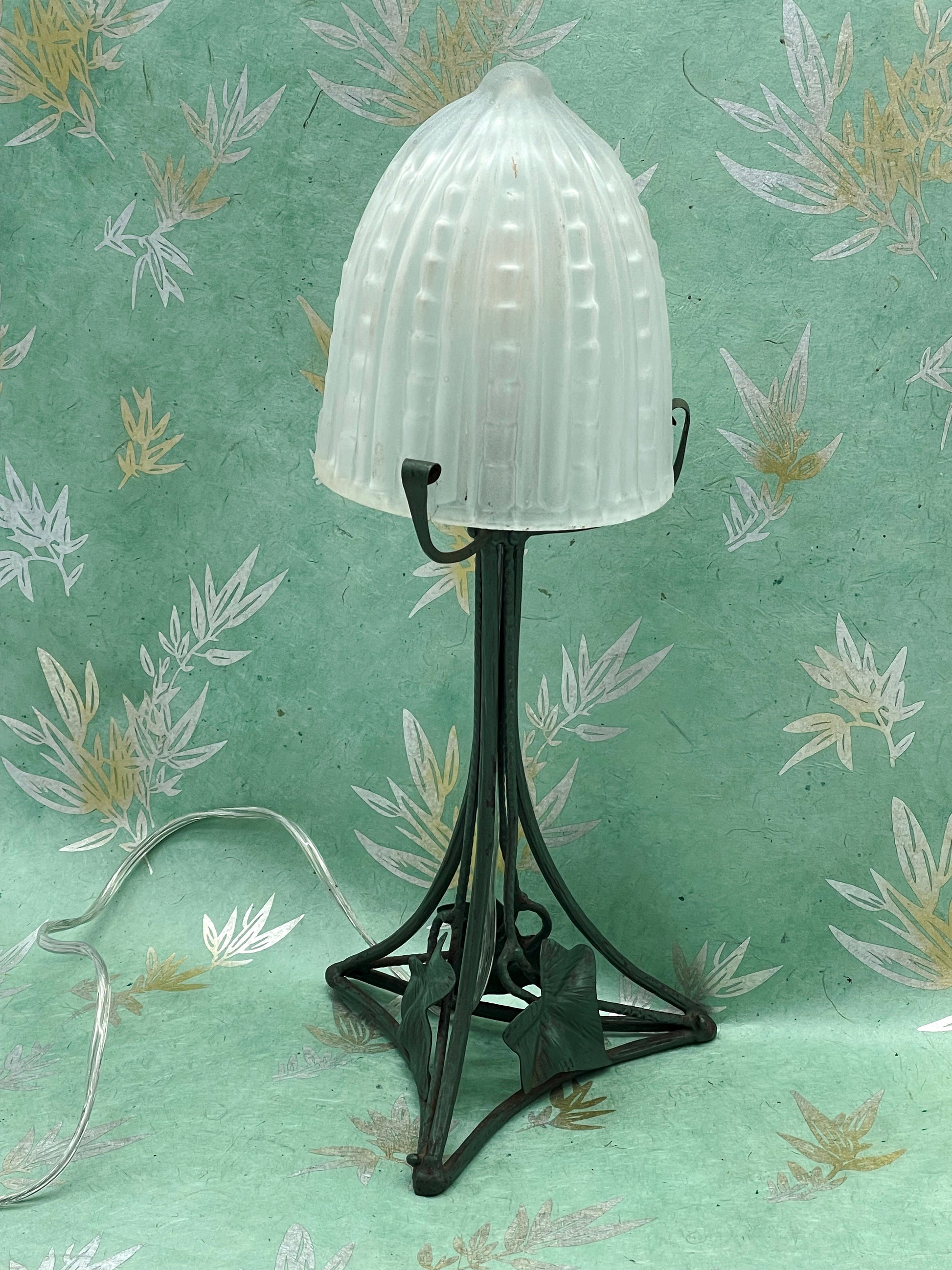 Wrought iron table lamp with glass dome, angle view