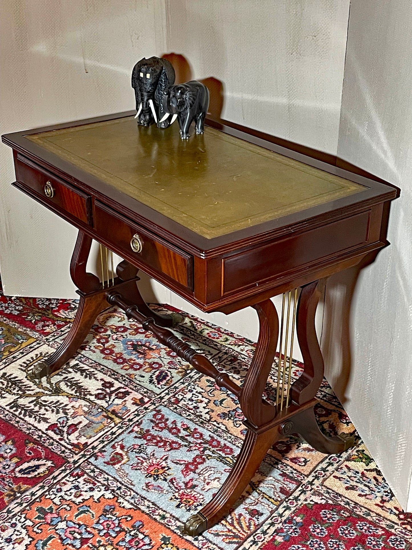 Lyre-end mahogany table viewed from above showing tooled green leather top and two drawers