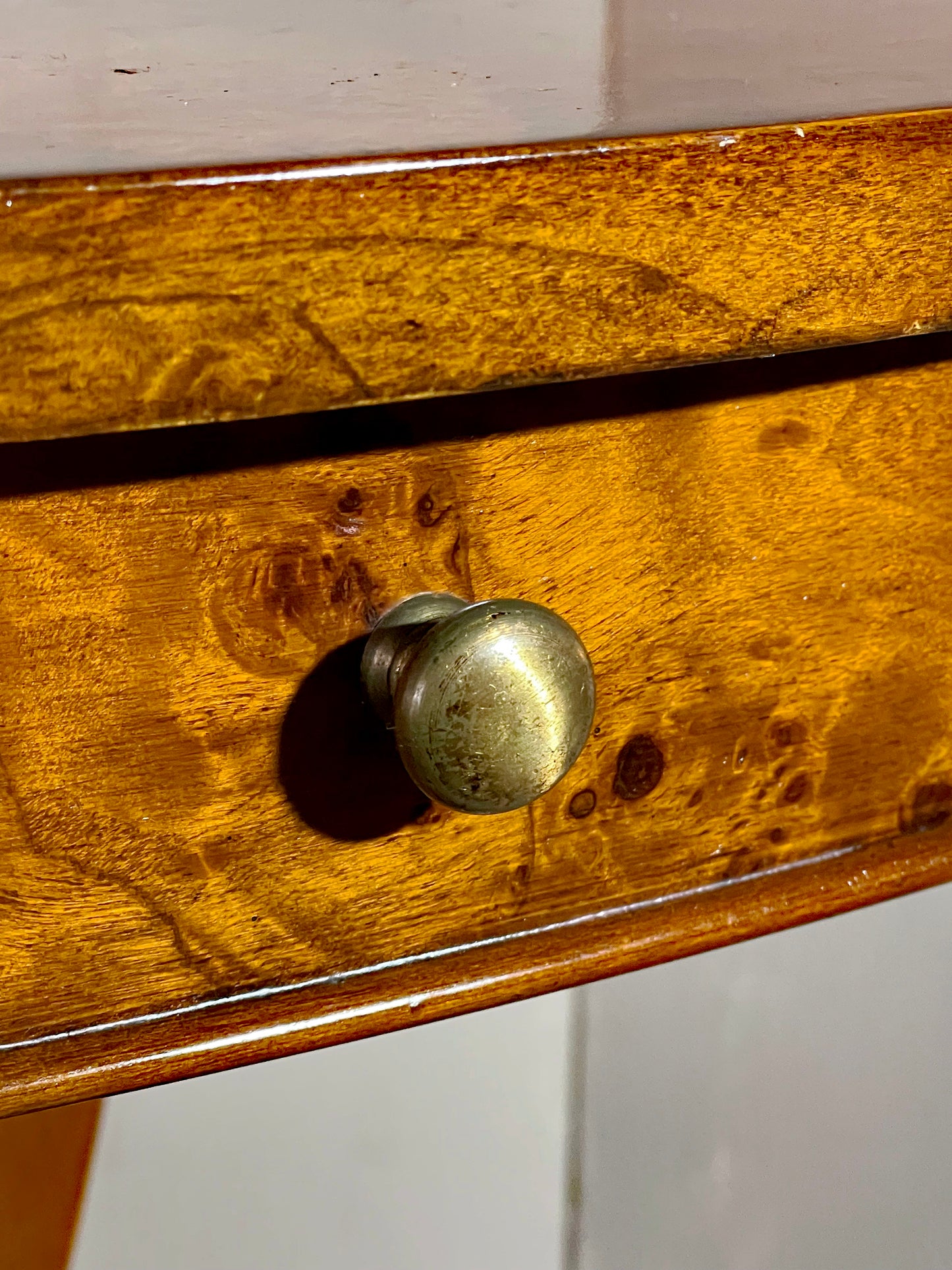 Original turned brass drawer knob and figured burl frieze