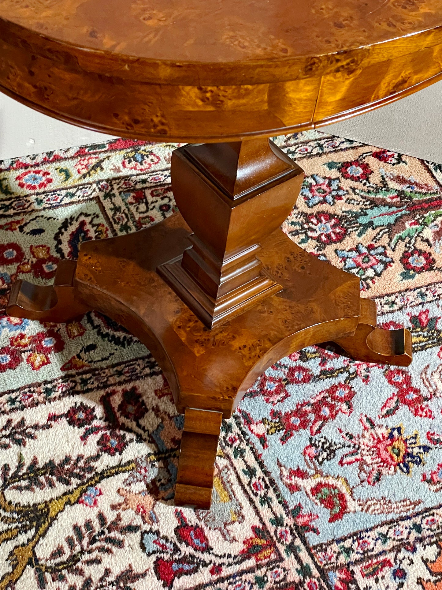 Sculptural tripod base of the oval pedestal table with scrolled feet
