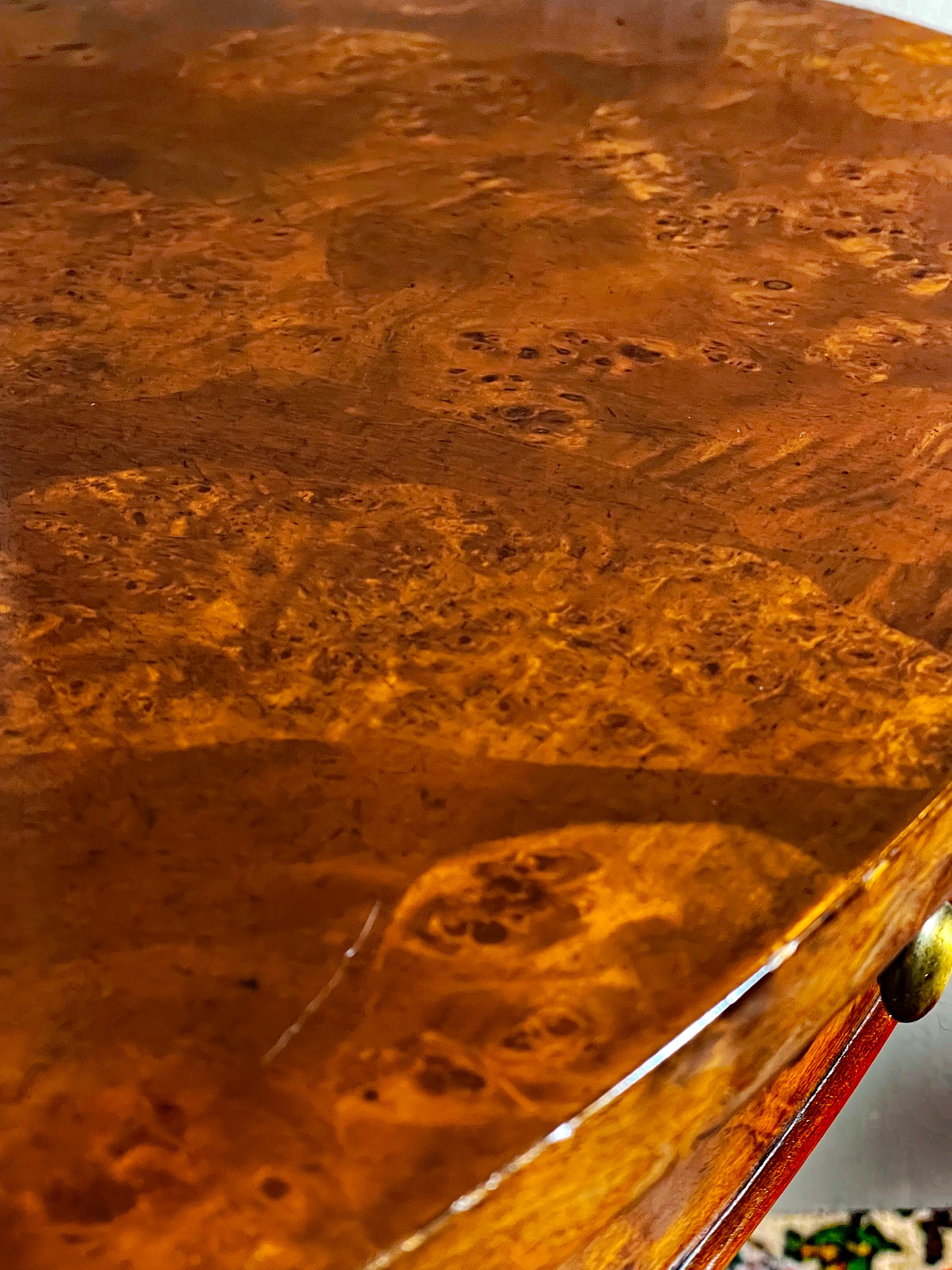Close-up of the lustrous figured burl wood oval tabletop