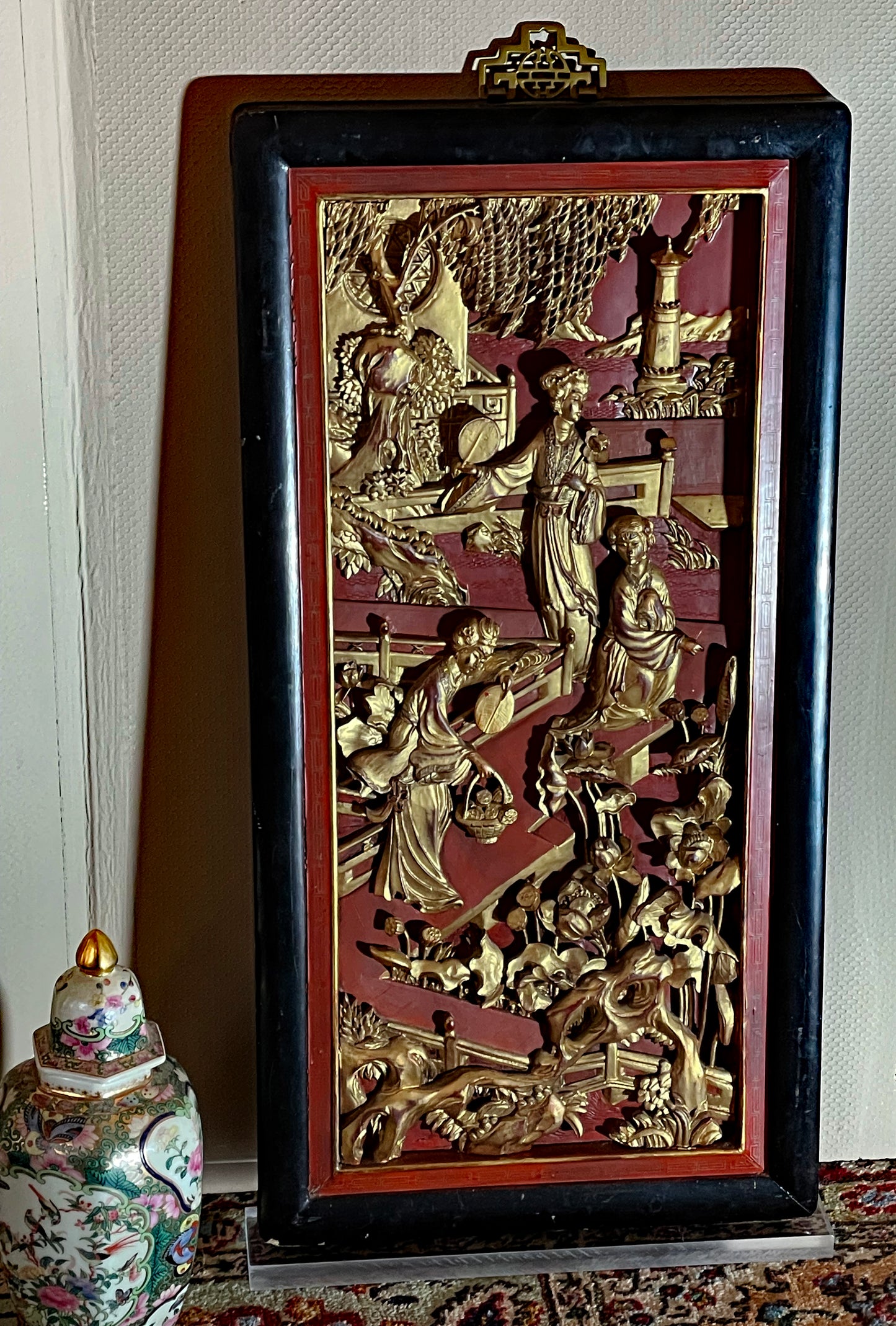 Large Chinese gilt-wood relief panel with figural court scene on red lacquer