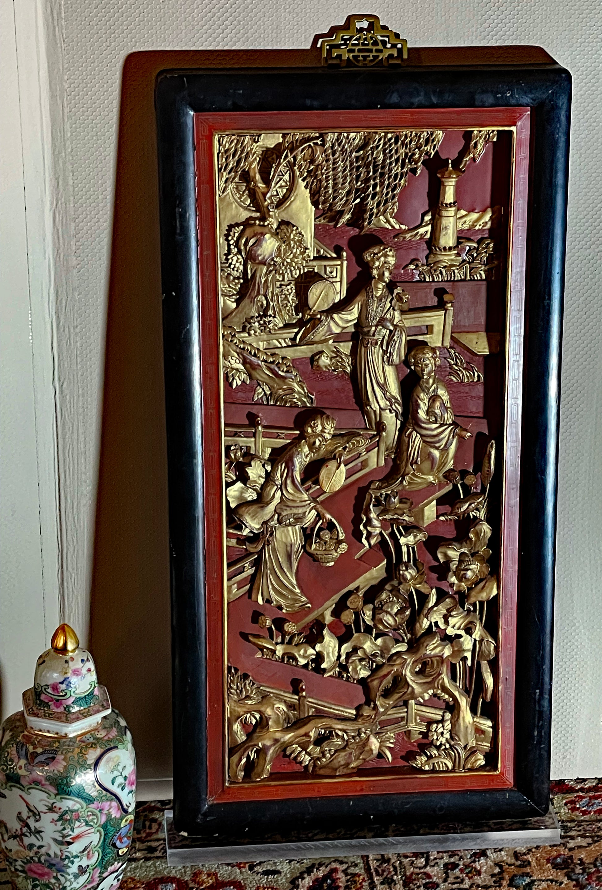 Large Chinese gilt-wood relief panel with figural court scene on red lacquer