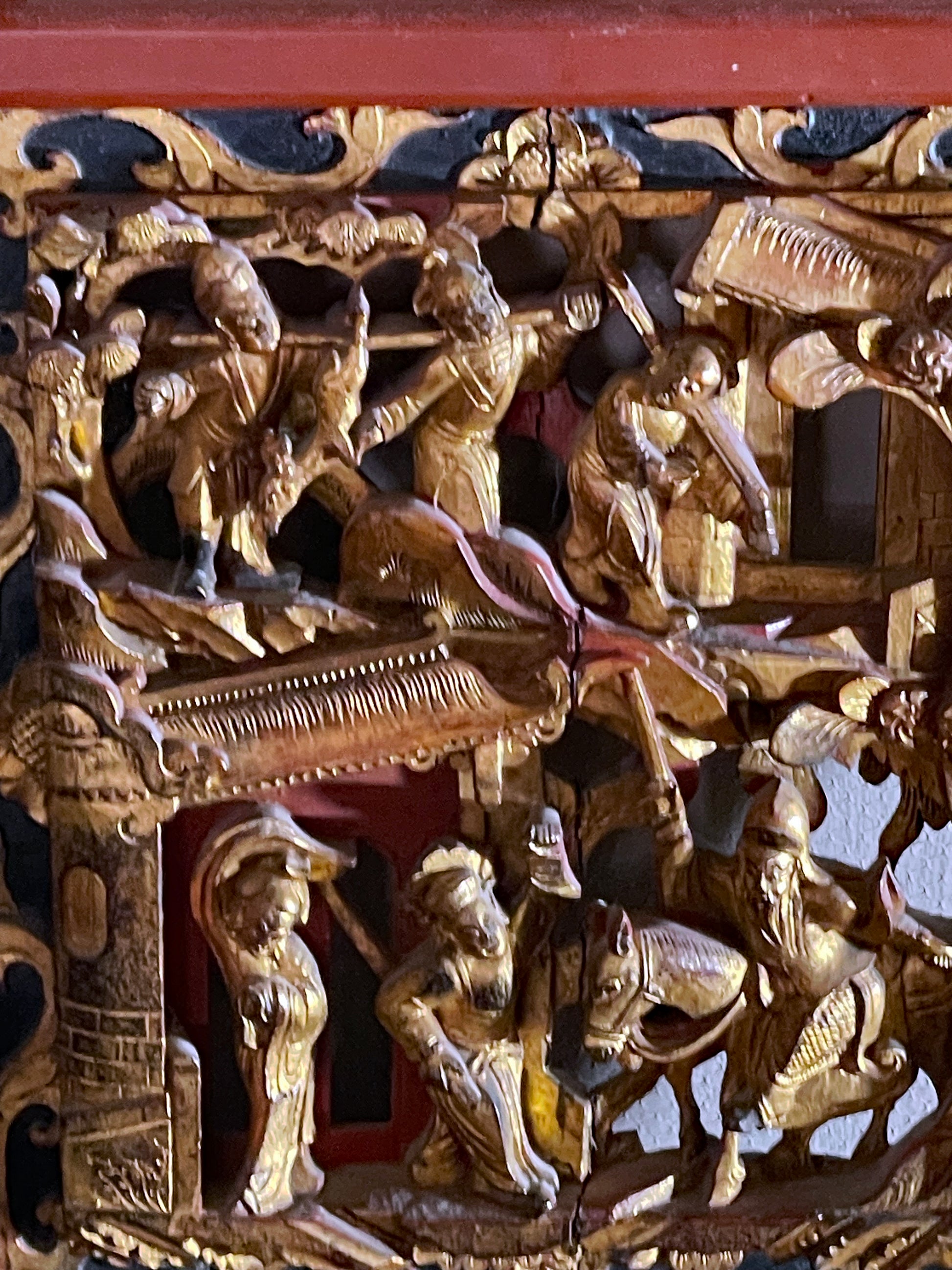 Gilded figural relief detail on Chinese decorative panel