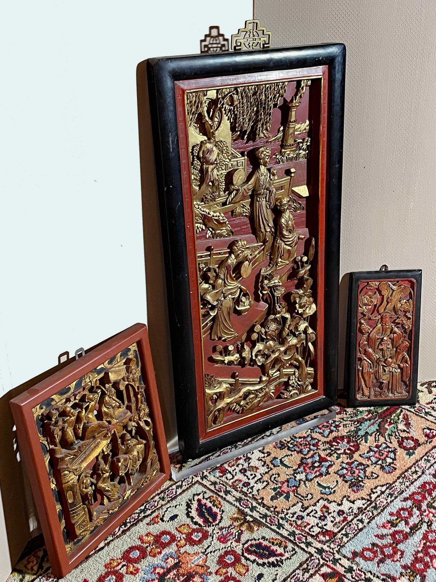 Set of three antique Chinese carved gilt-wood relief panels with lacquer frames