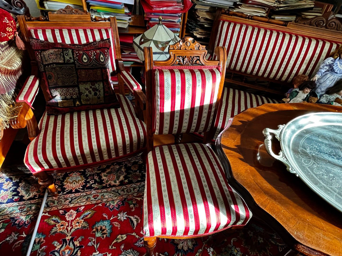 Pair of Biedermeier armchairs with carved walnut crests and striped upholstery