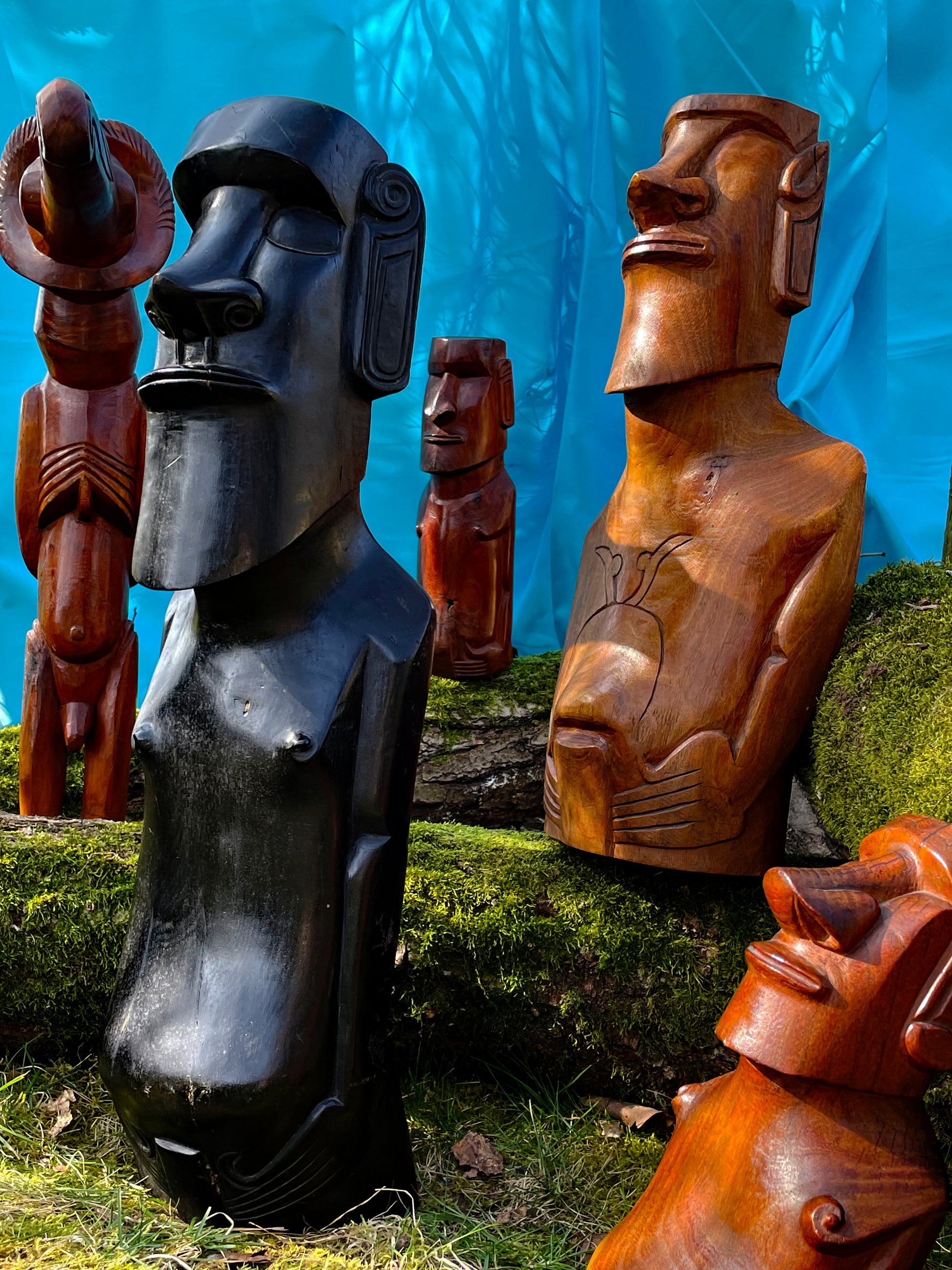 Group of five Rapa Nui Moai wood figures shown at an angle