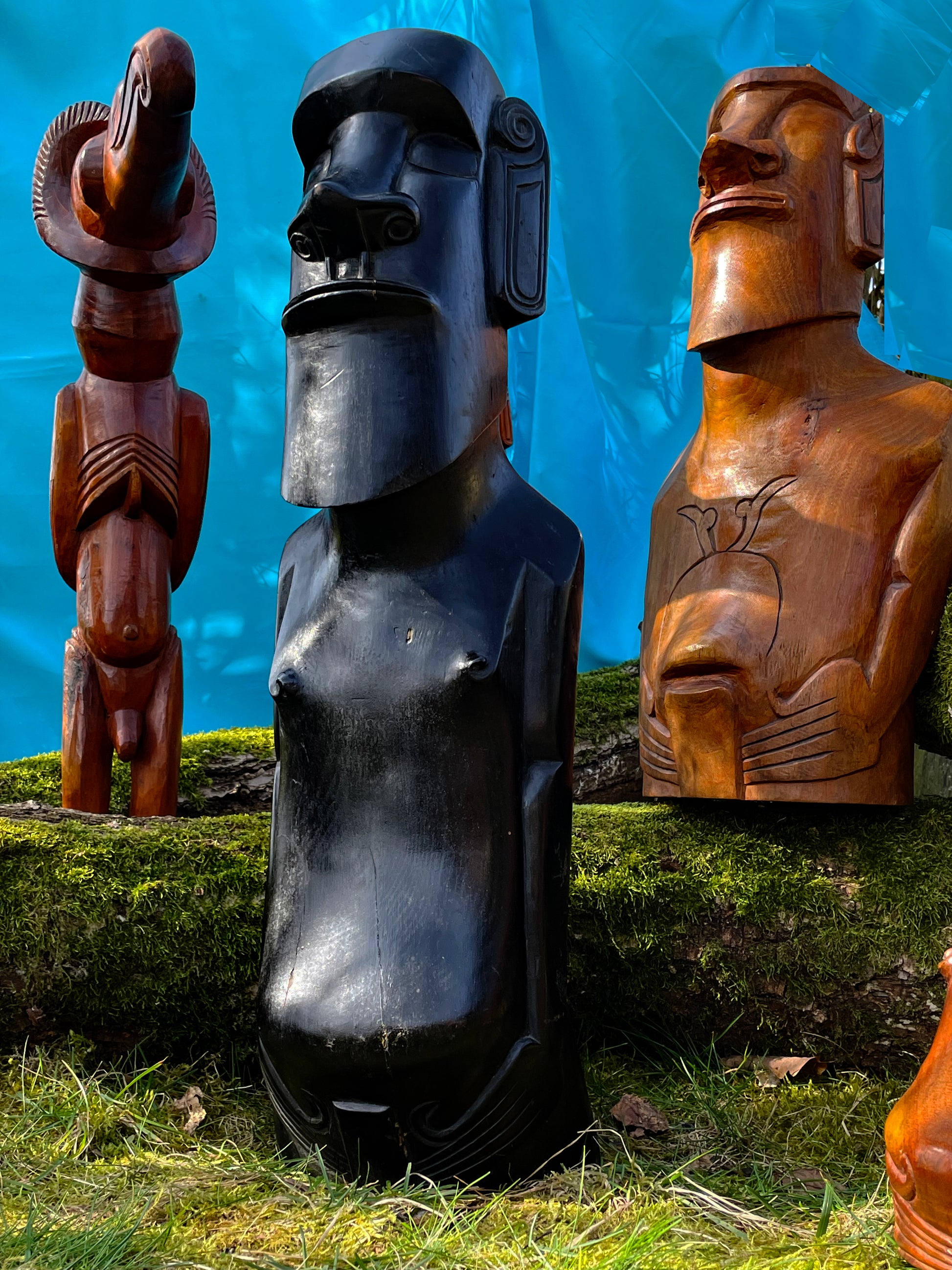 Carved Moai busts showing detailed chest and torso carving