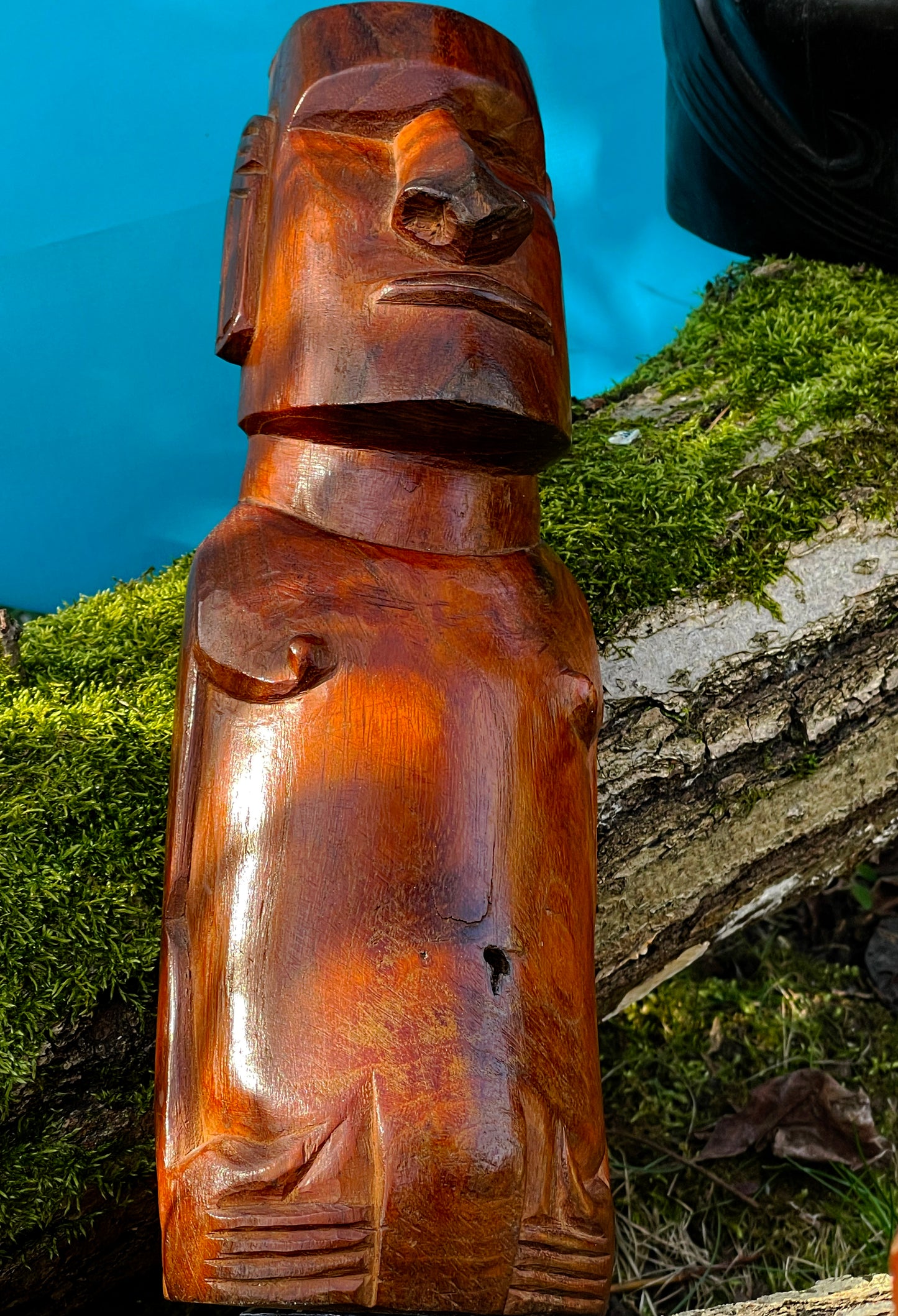 Close-up of a small orange brown Easter Island Moai figure