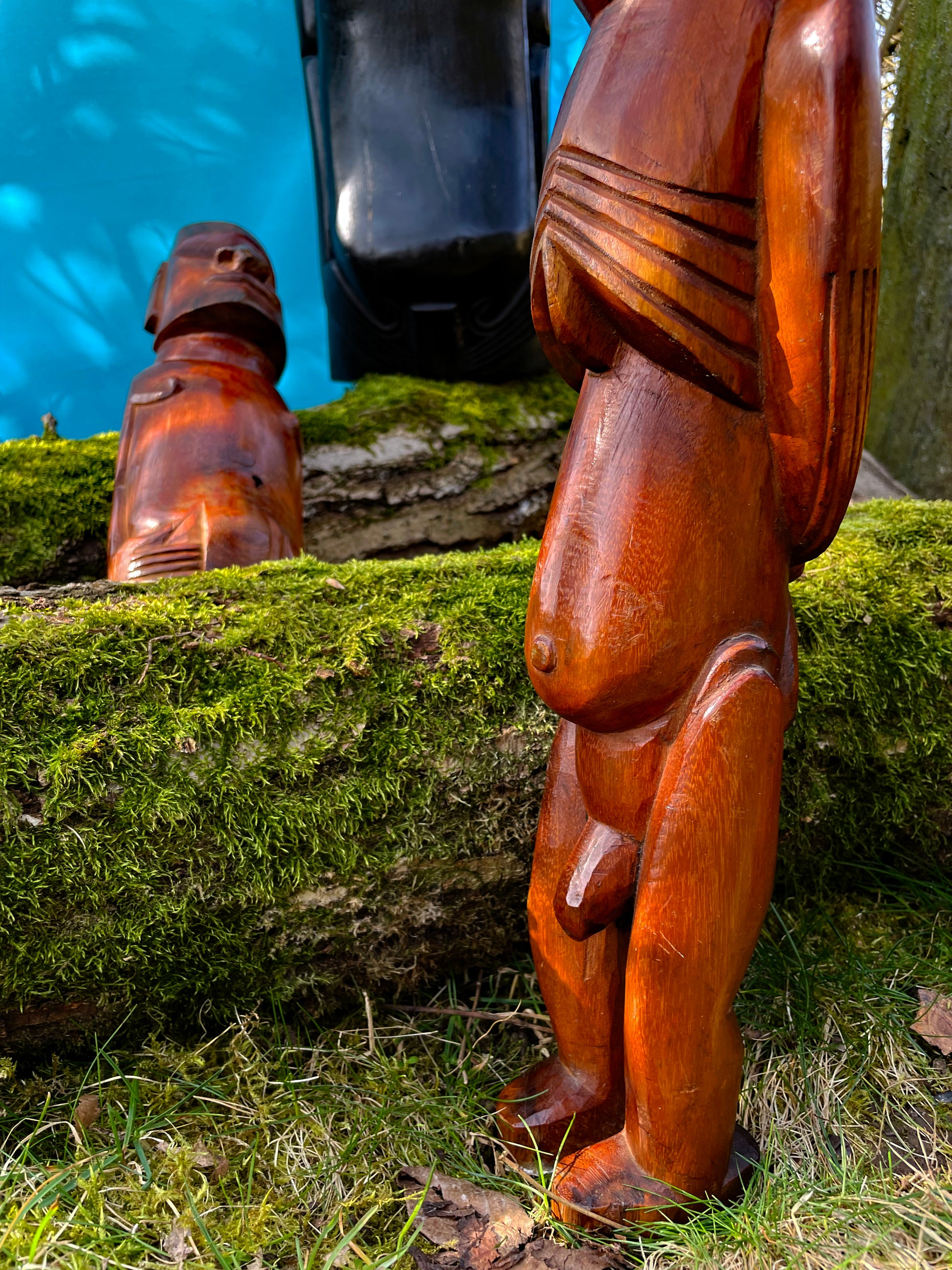 Honey-toned Rapa Nui figure showing carved back and sash detail