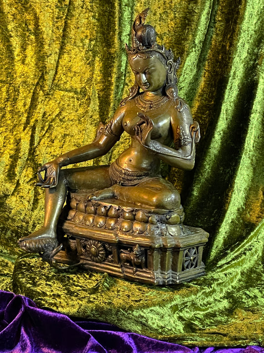 Antique Tibetan bronze Green Tara statue seated in royal ease on a lotus throne, three quarter view, 41 cm