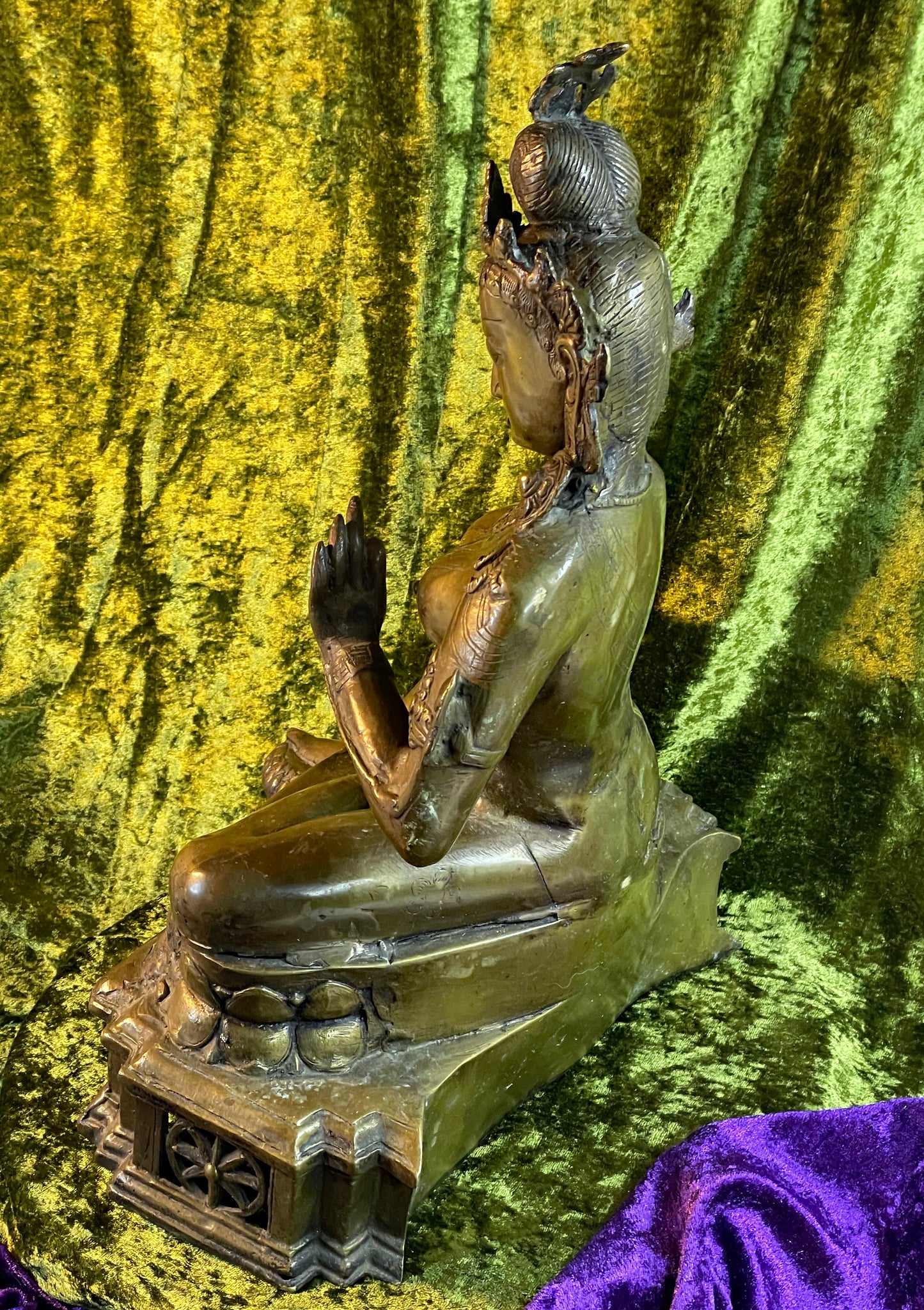 Rear view of the bronze Tara showing the back, lotus throne and ornate base