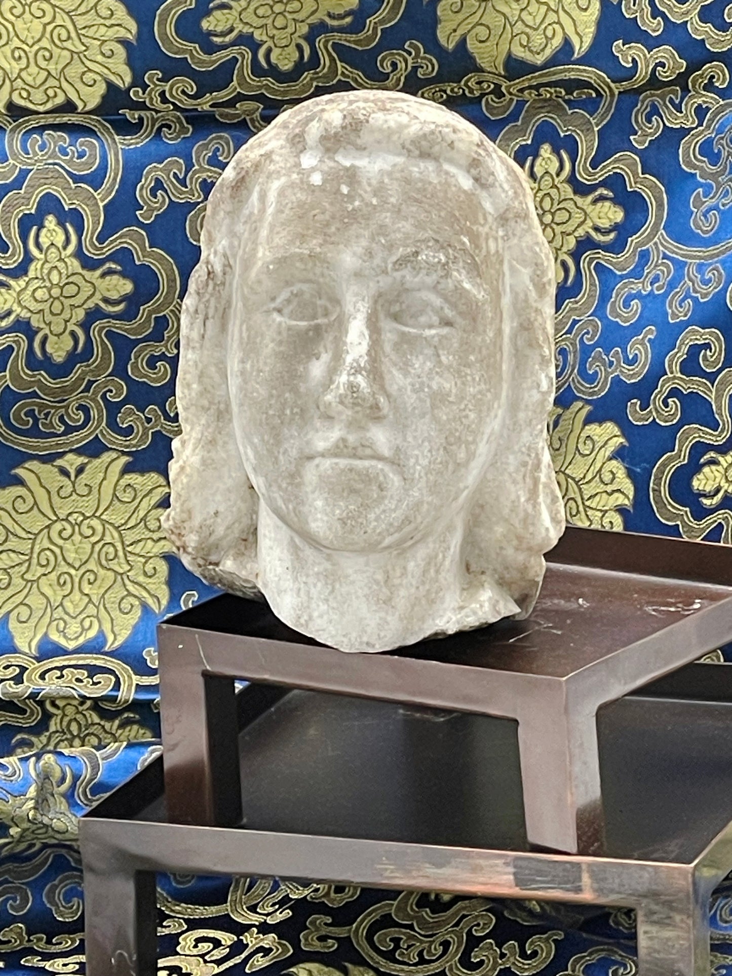 Front view of carved marble angel face