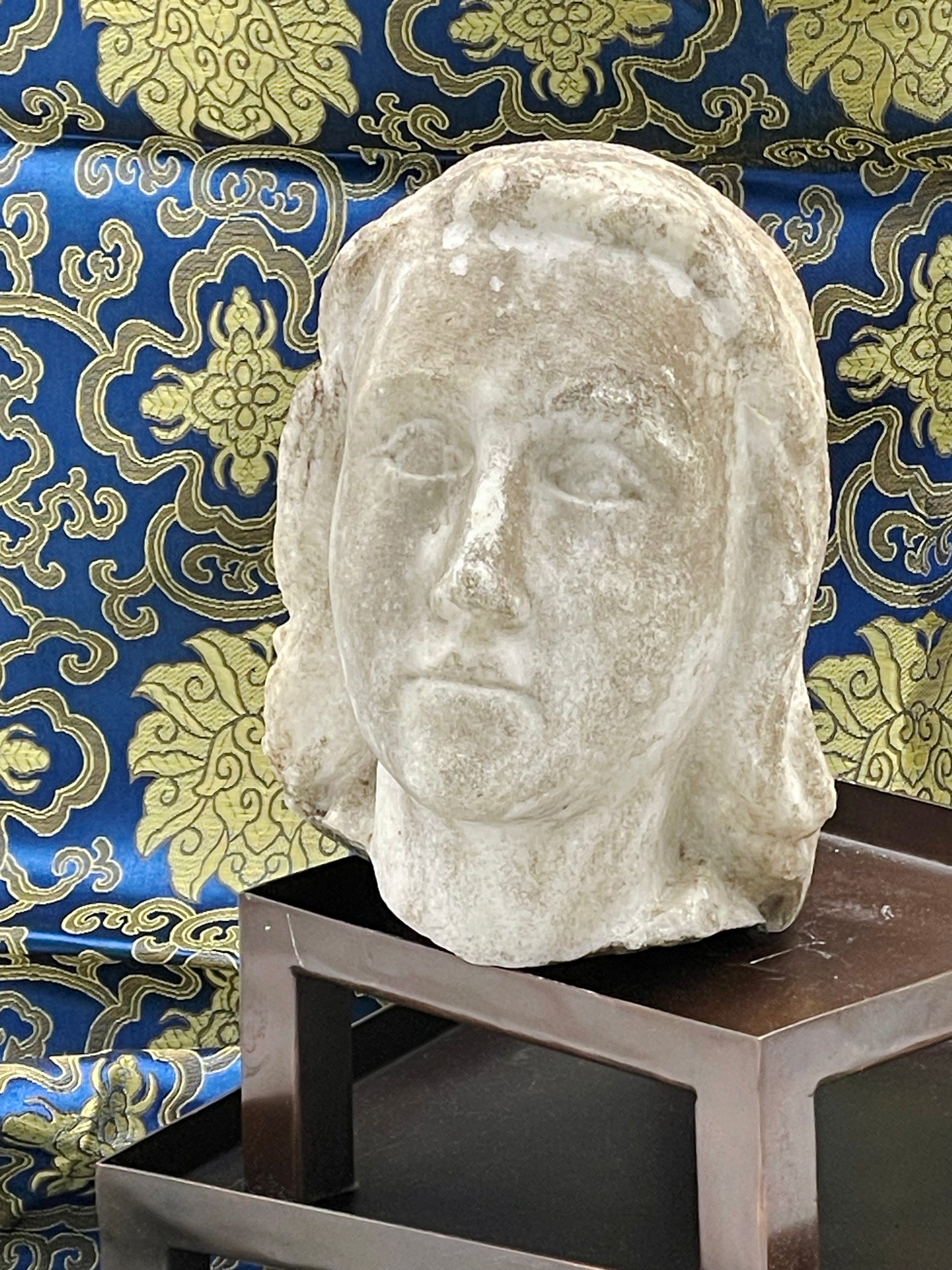 Side profile of antique marble angel sculpture