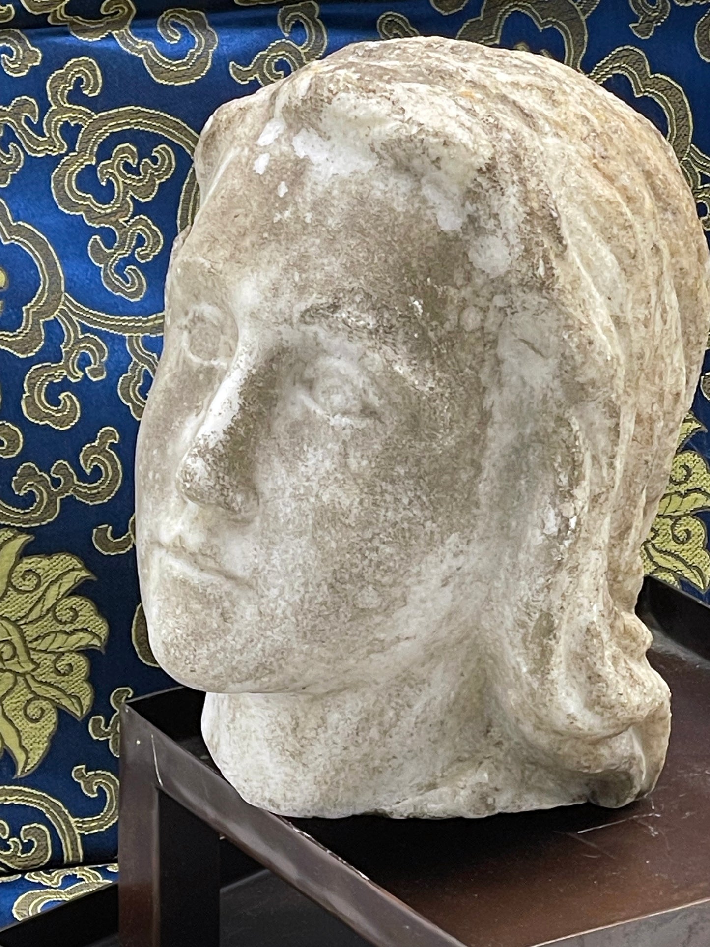 Detail of serene carved marble facial features