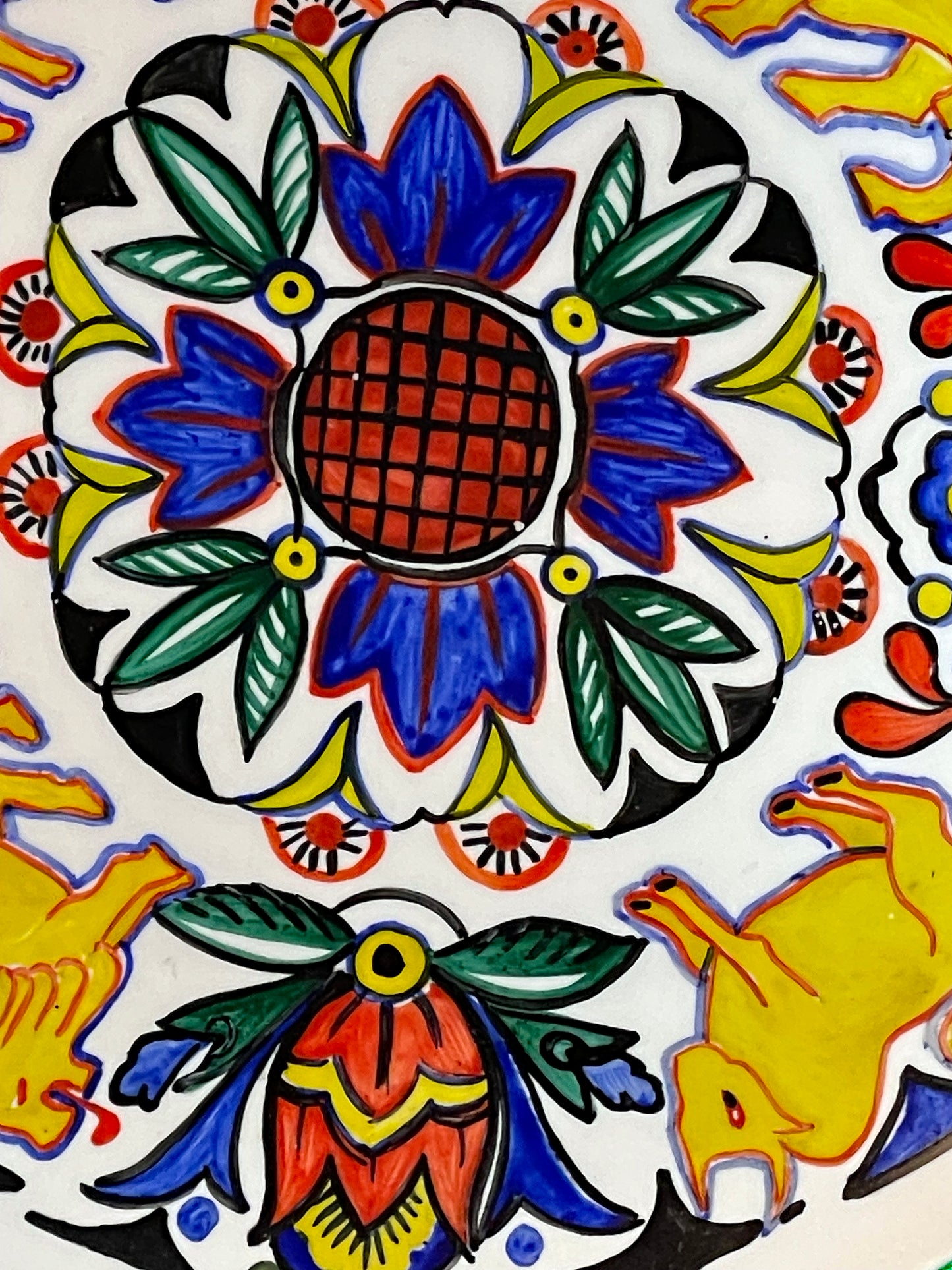 Close detail of the central floral medallion with cobalt petals and lattice center